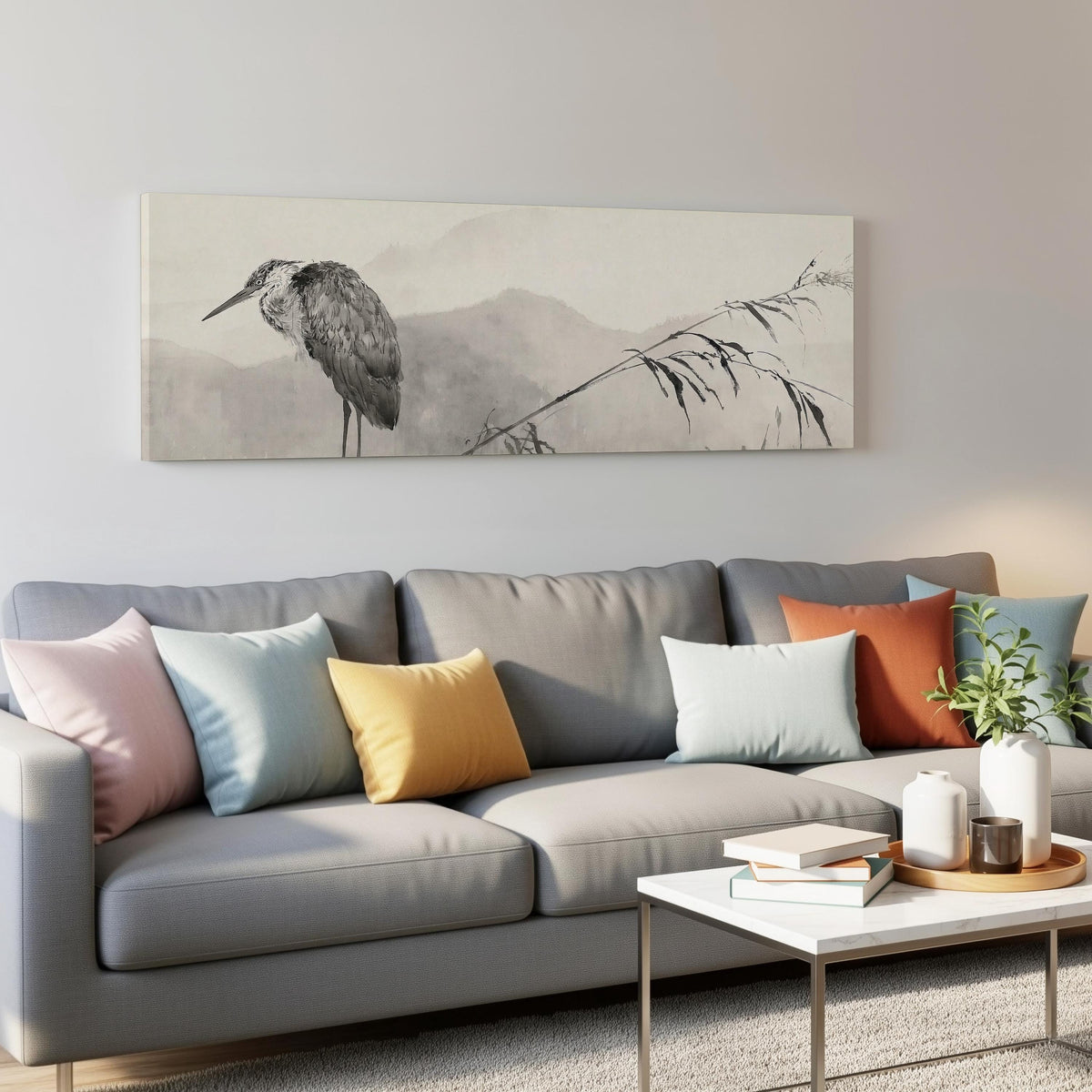 Heron in front of misty ink mountains panoramic canvas print above a grey sofa in a living room