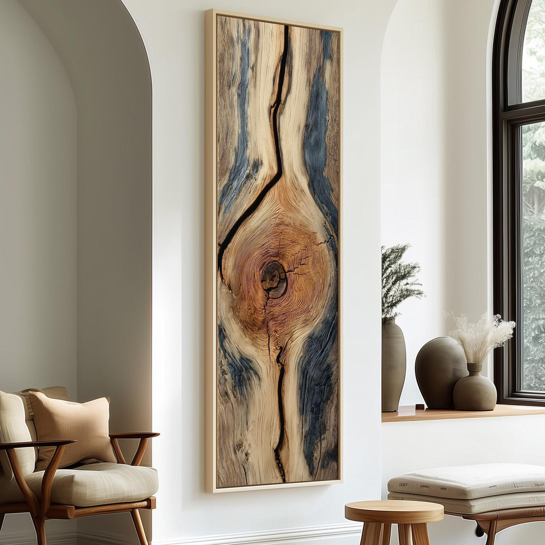 a large, abstract painting of a tree trunk with a unique, textured pattern. The painting is hanging on a wall, and there is a vase of flowers placed next to it.