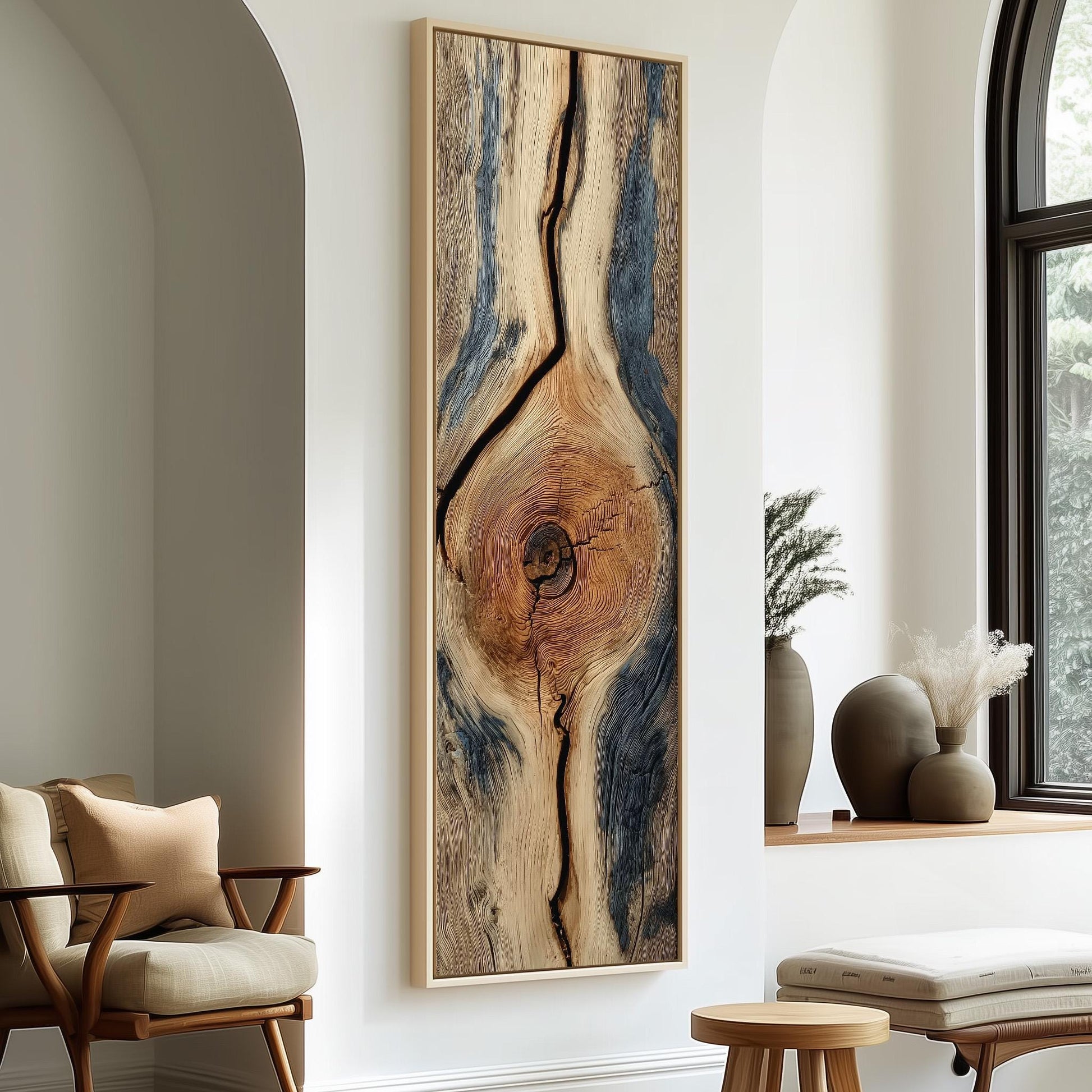 a modern living room with a large, abstract wooden artwork hanging on the wall. The artwork has a striking design with a central tree trunk and a pattern of blue and brown lines. The room is furnished with a wooden chair, a small table, and a window with white curtains.