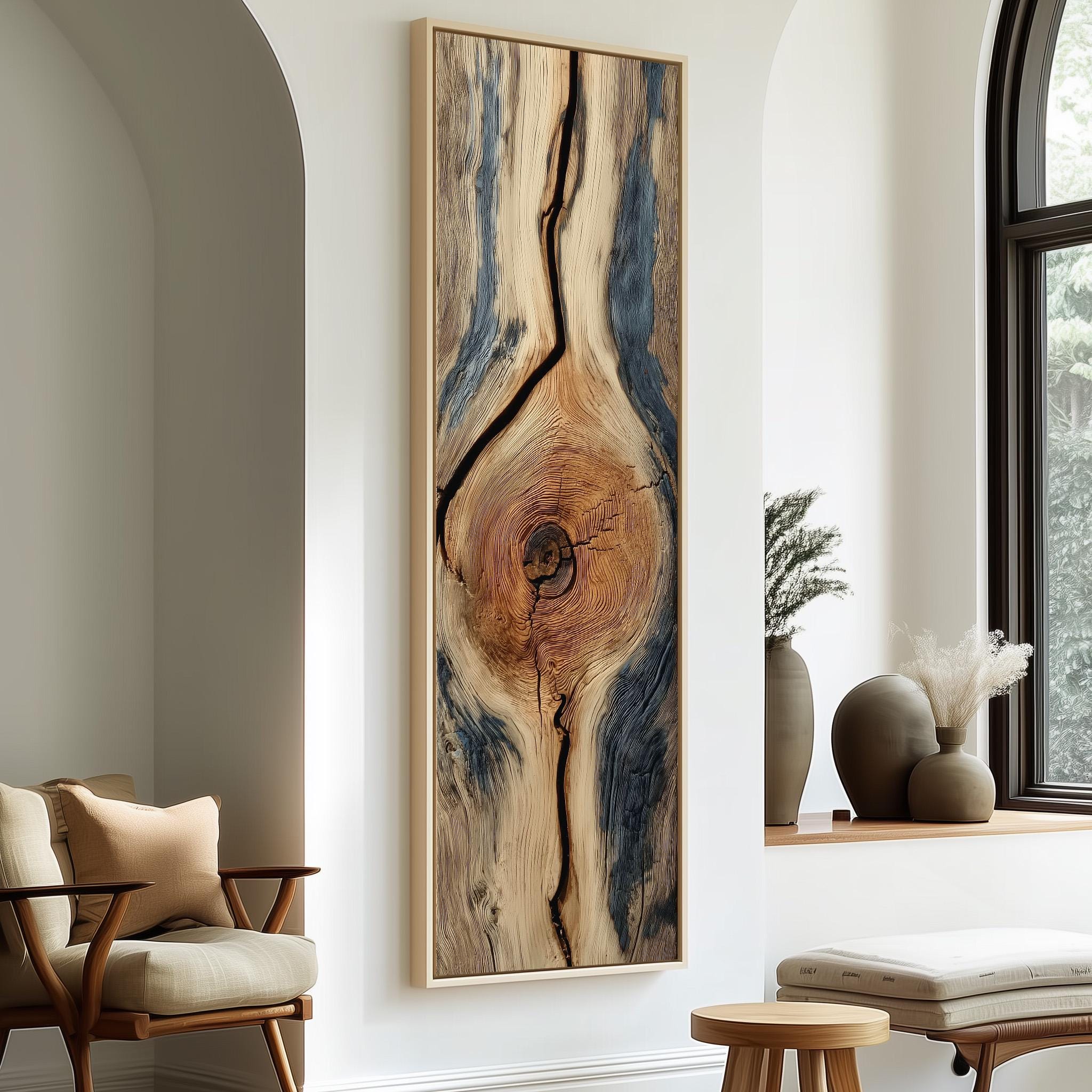 a modern living room with a large, abstract wooden artwork hanging on the wall. The artwork has a striking design with a central tree trunk and a pattern of blue and brown lines. The room is furnished with a wooden chair, a small table, and a window with white curtains.