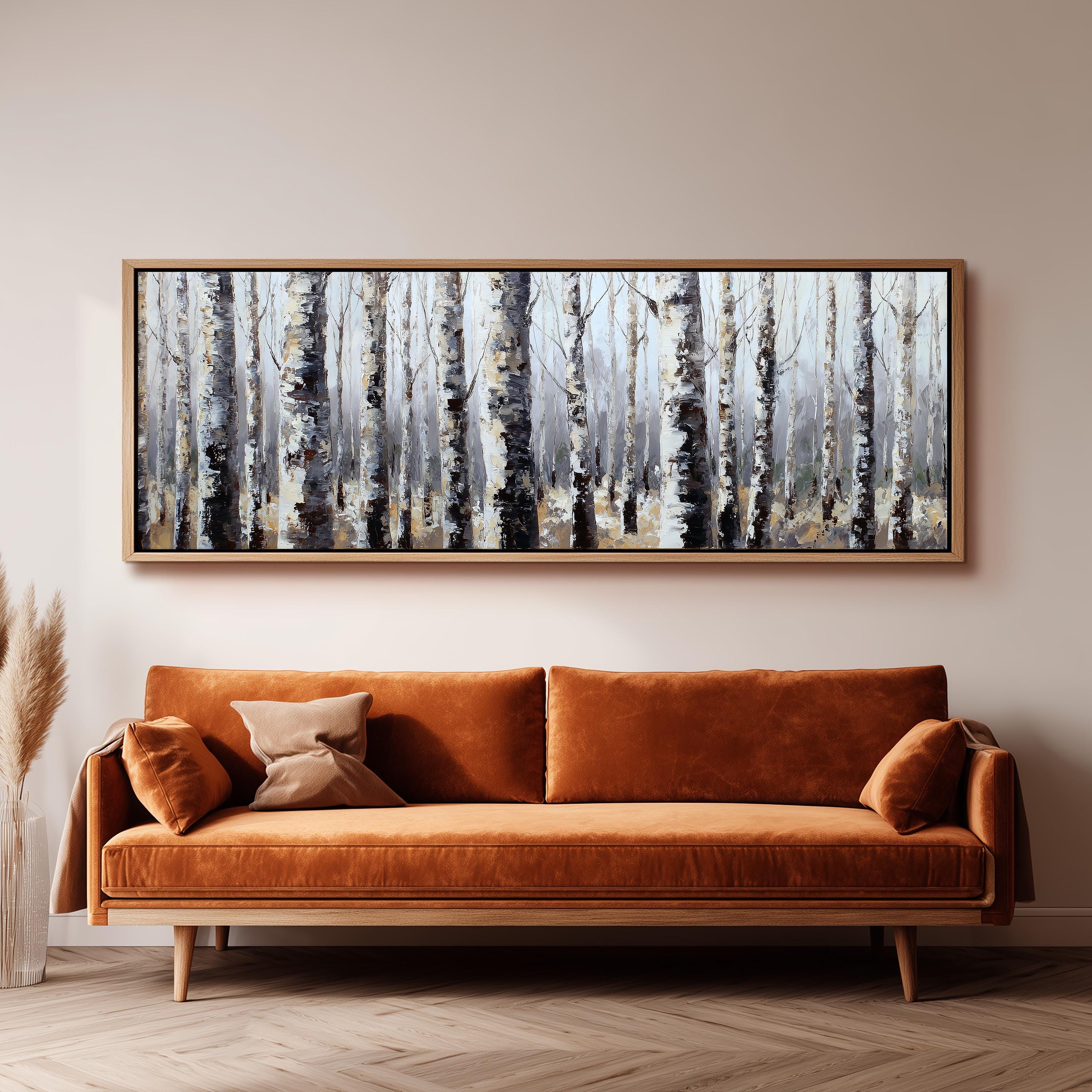 a large, framed painting of a forest scene hanging on a wall above a brown sofa.