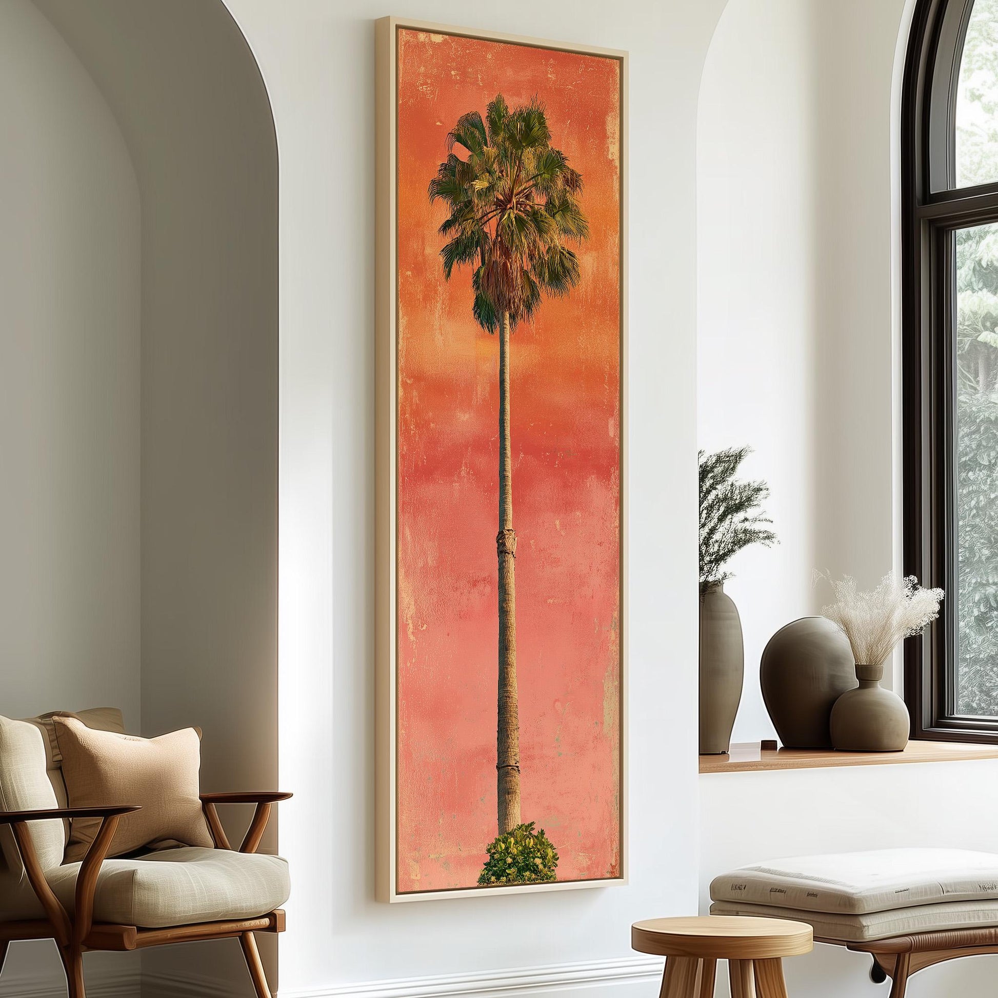 a large framed painting of a palm tree on a wall, with a wooden chair and a small table in the foreground.