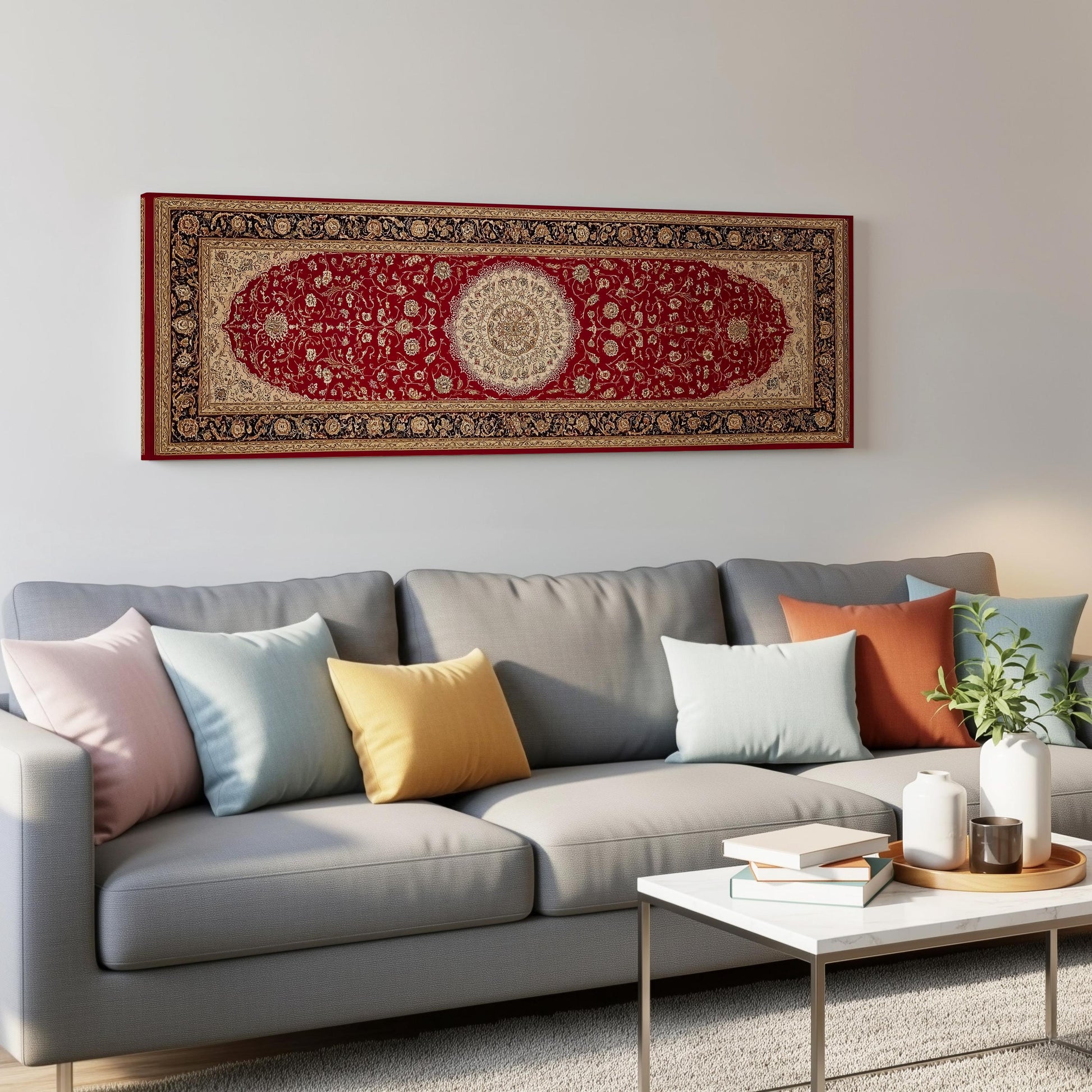a gray sofa with colorful throw pillows, a white coffee table, and a large red and gold rug hanging on the wall above the sofa.