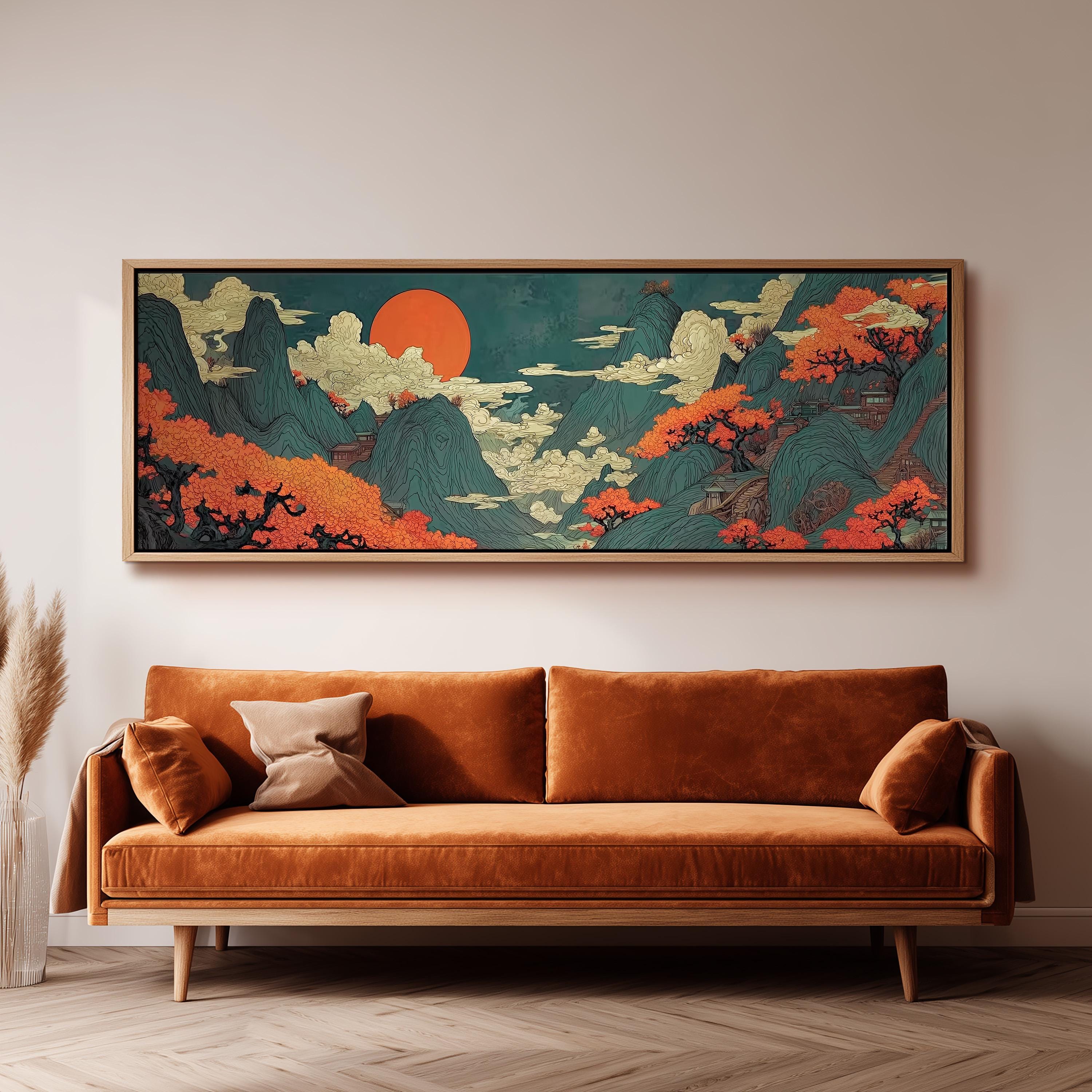 a large, colorful painting of a mountainous landscape with a prominent orange sun in the sky, hanging on a wall above a brown sofa.