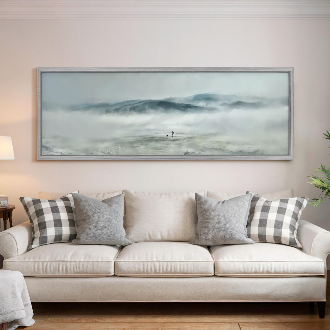 a large, framed painting of a landscape with a person standing in the middle of a misty, mountainous area.