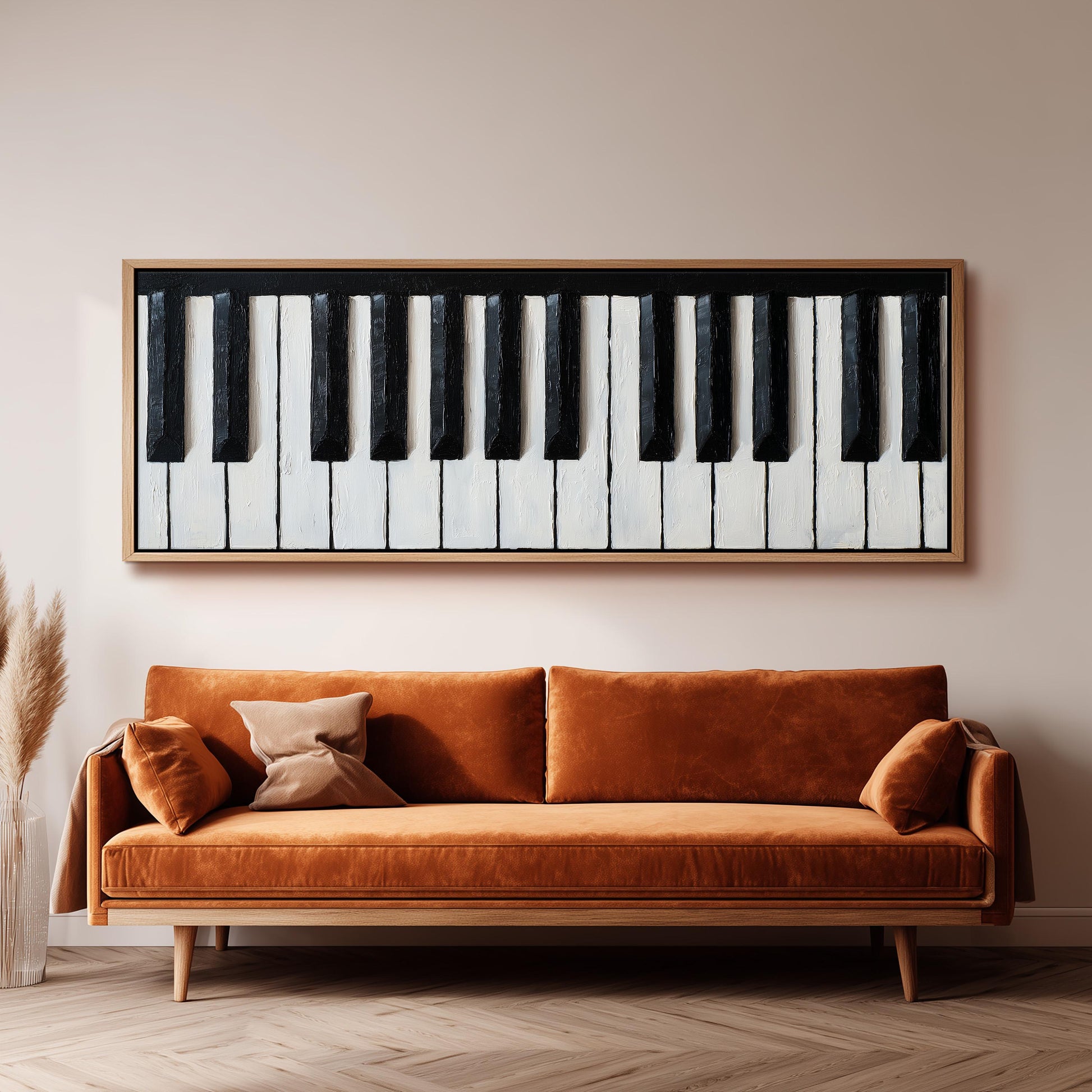 a large, framed painting of a piano keyboard hanging on a wall above a brown sofa.