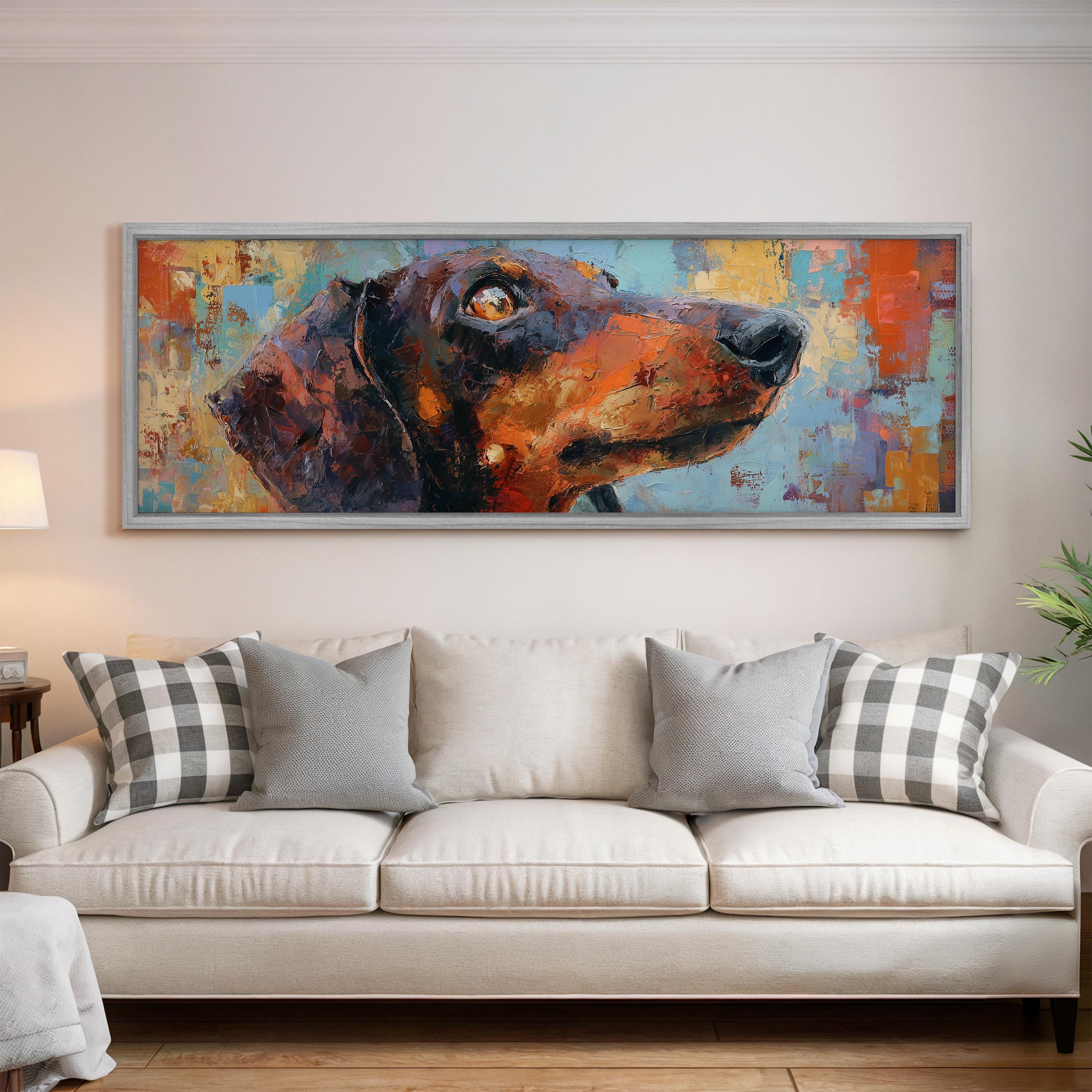 a large, colorful painting of a dog's head hanging on a wall above a white couch with gray and white plaid throw pillows.