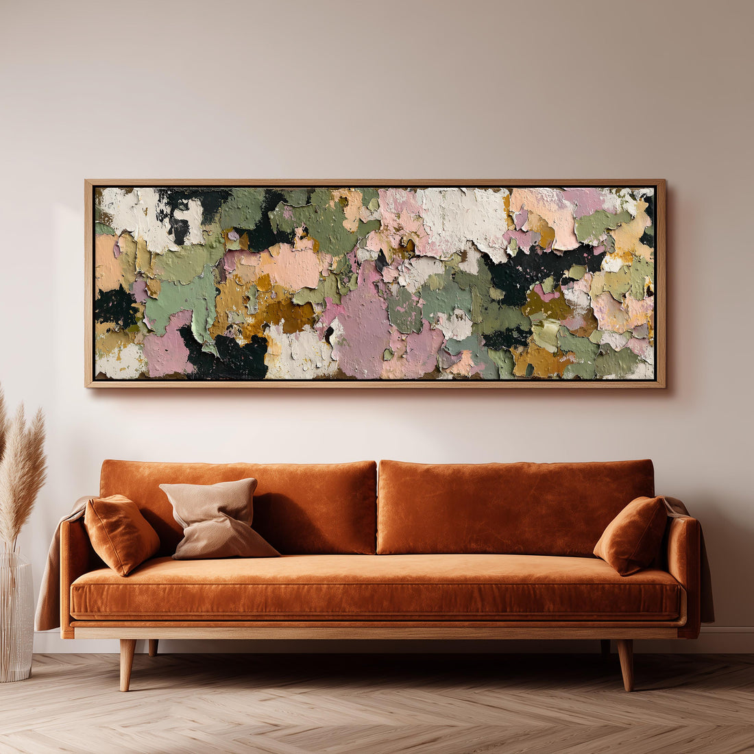 a large, abstract painting hanging on a wall above a brown sofa with orange cushions.
