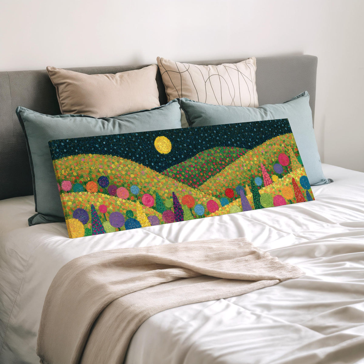 Moonlit pastel flower hills wide panoramic canvas print laid on a bed to show its size