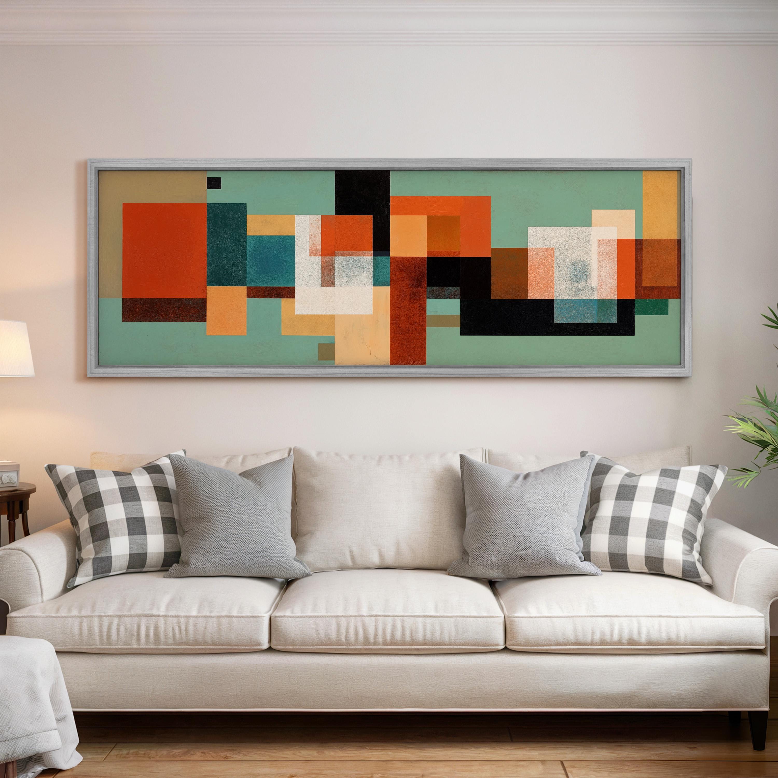 a large abstract painting hanging on a wall above a white couch with gray and black plaid throw pillows.