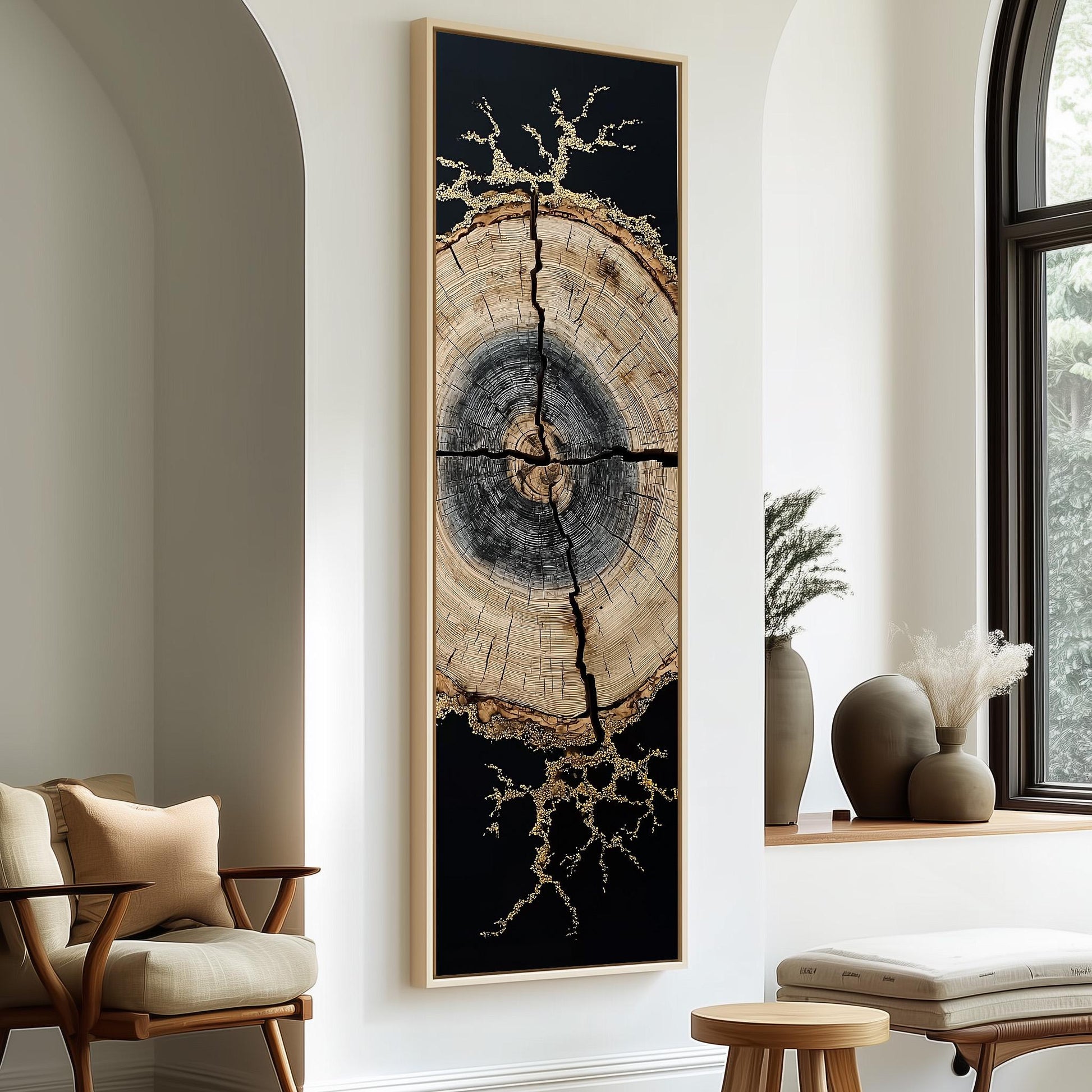 a large, abstract painting of a tree trunk with a black background and gold accents, hanging on a white wall. The painting is framed in black and is positioned between two chairs, one on each side. The room also includes a window, a small table, and some decorative elements such as vases and a potted plant.