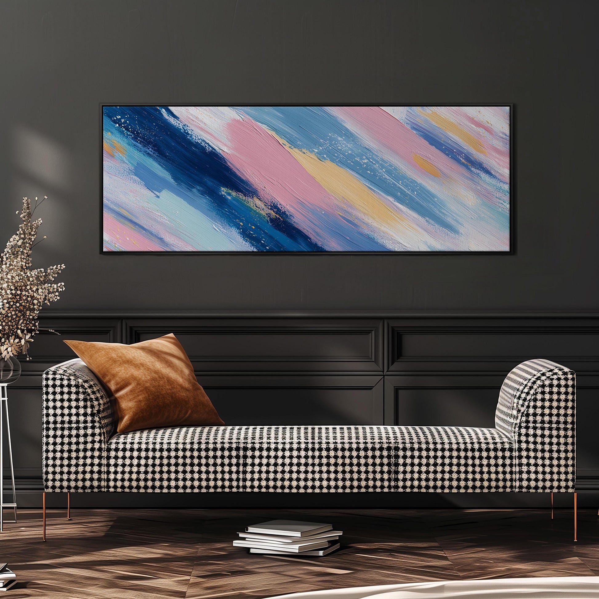 a modern living room with a black and white checkered sofa, a stack of books, and a large abstract painting hanging on the wall above the sofa.