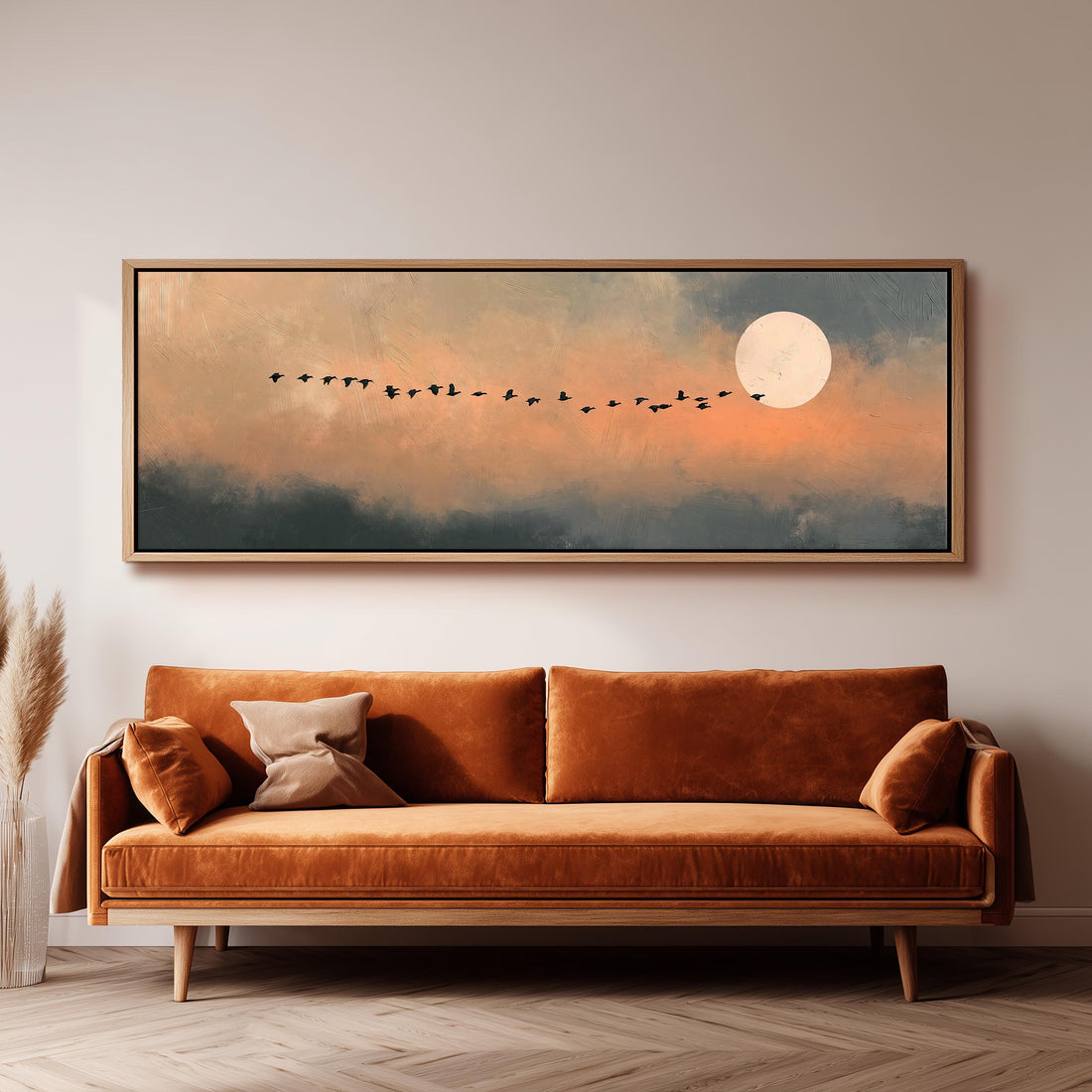Geese flying toward the moon at twilight long horizontal canvas print above a sofa in a living room
