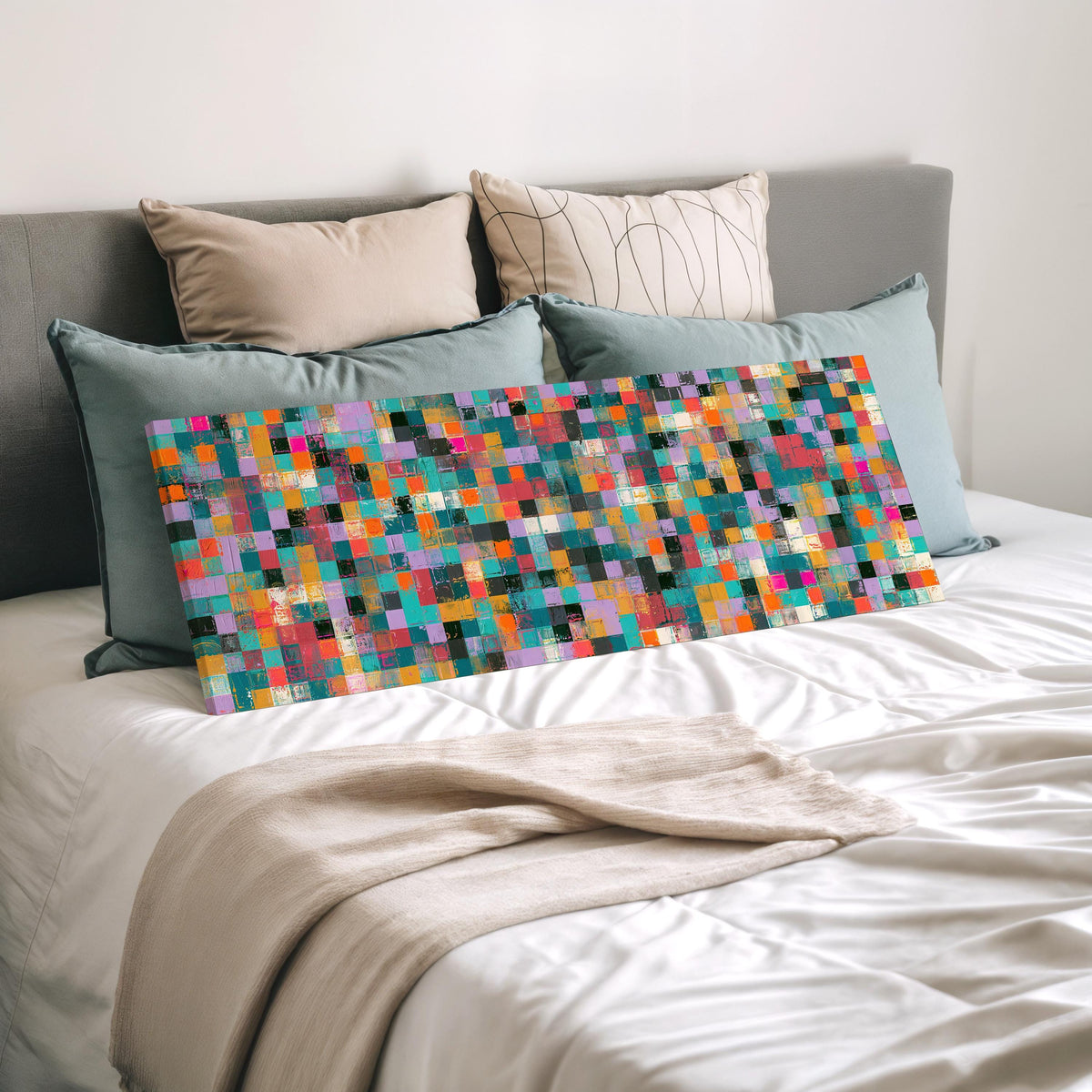Jewel tone checker mosaic wide panoramic canvas print laid on a bed to show its size