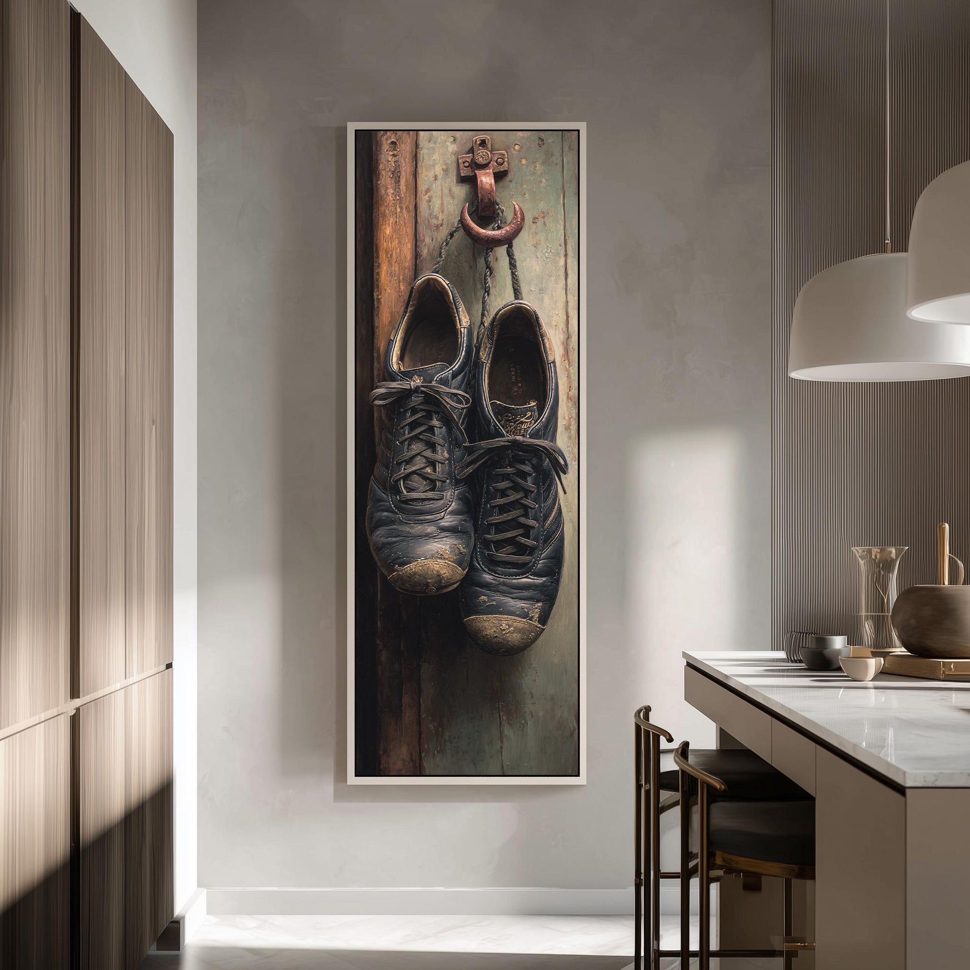 a pair of worn black shoes hanging on a wooden door, with a framed photograph of the shoes displayed on the wall.
