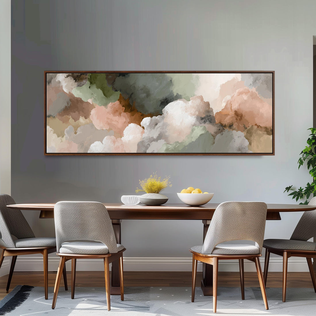 a dining room with a large abstract painting hanging on the wall above a wooden table with four chairs. The table is set with a bowl of fruit and a vase of flowers, creating a cozy and inviting atmosphere.