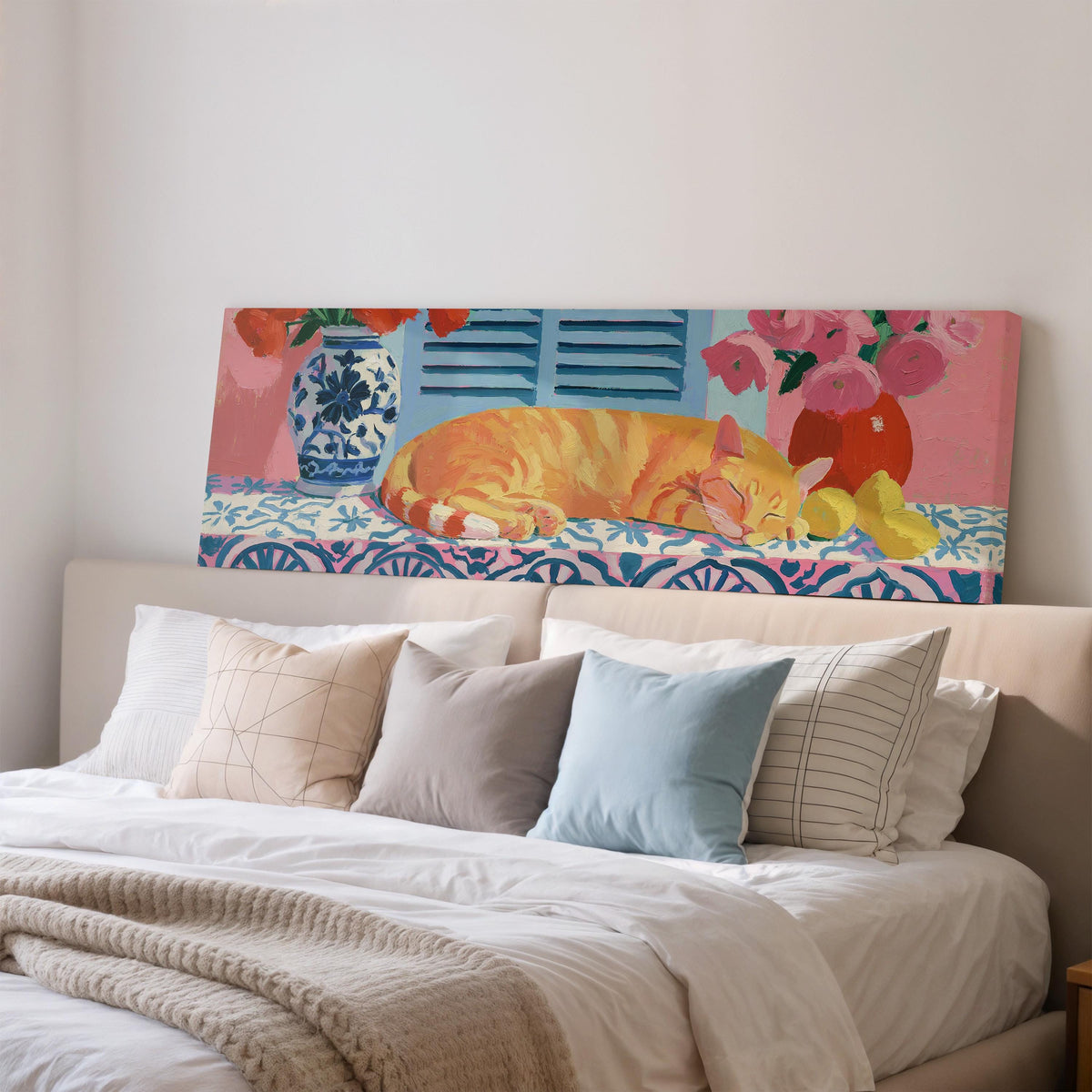 Orange cat napping on a tiled table wide panoramic canvas print above a bed in a bedroom
