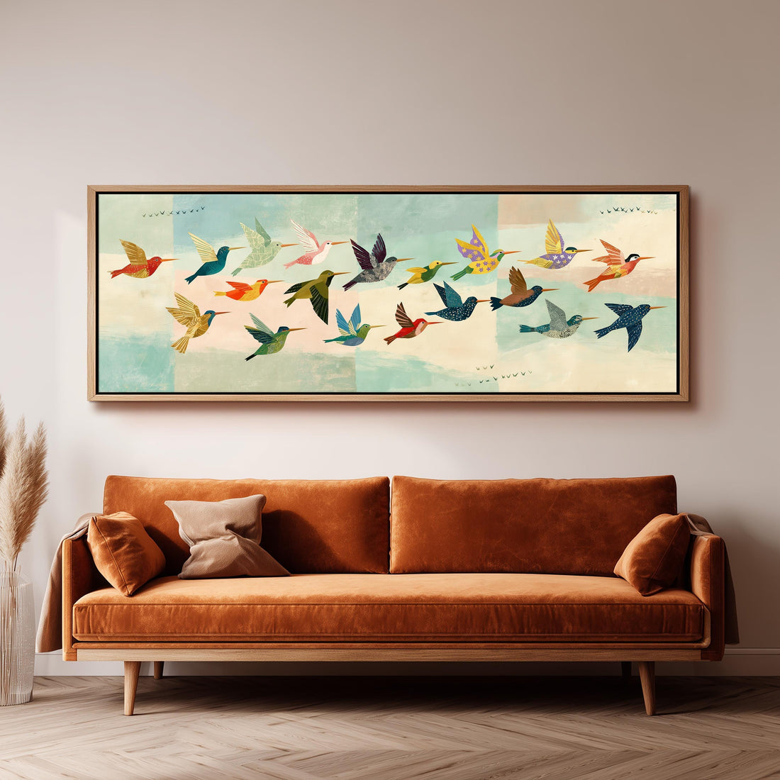 Flock of colorful hummingbirds long horizontal canvas print above a sofa in a living room