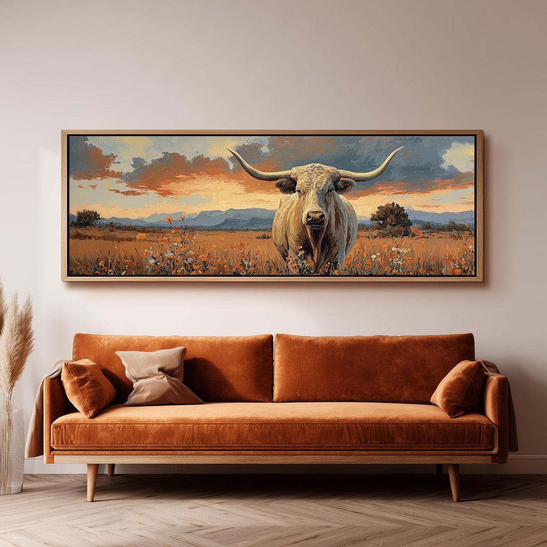 a large painting of a bull with horns, hanging on a wall above a wooden dining table with four chairs.