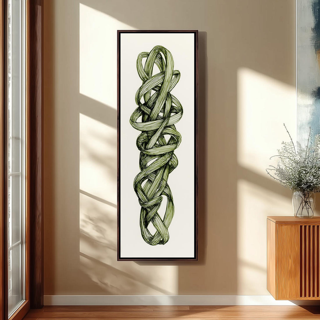 a large framed artwork of a green plant with twisted, intertwined leaves hanging on a wall in a room with wooden paneling.