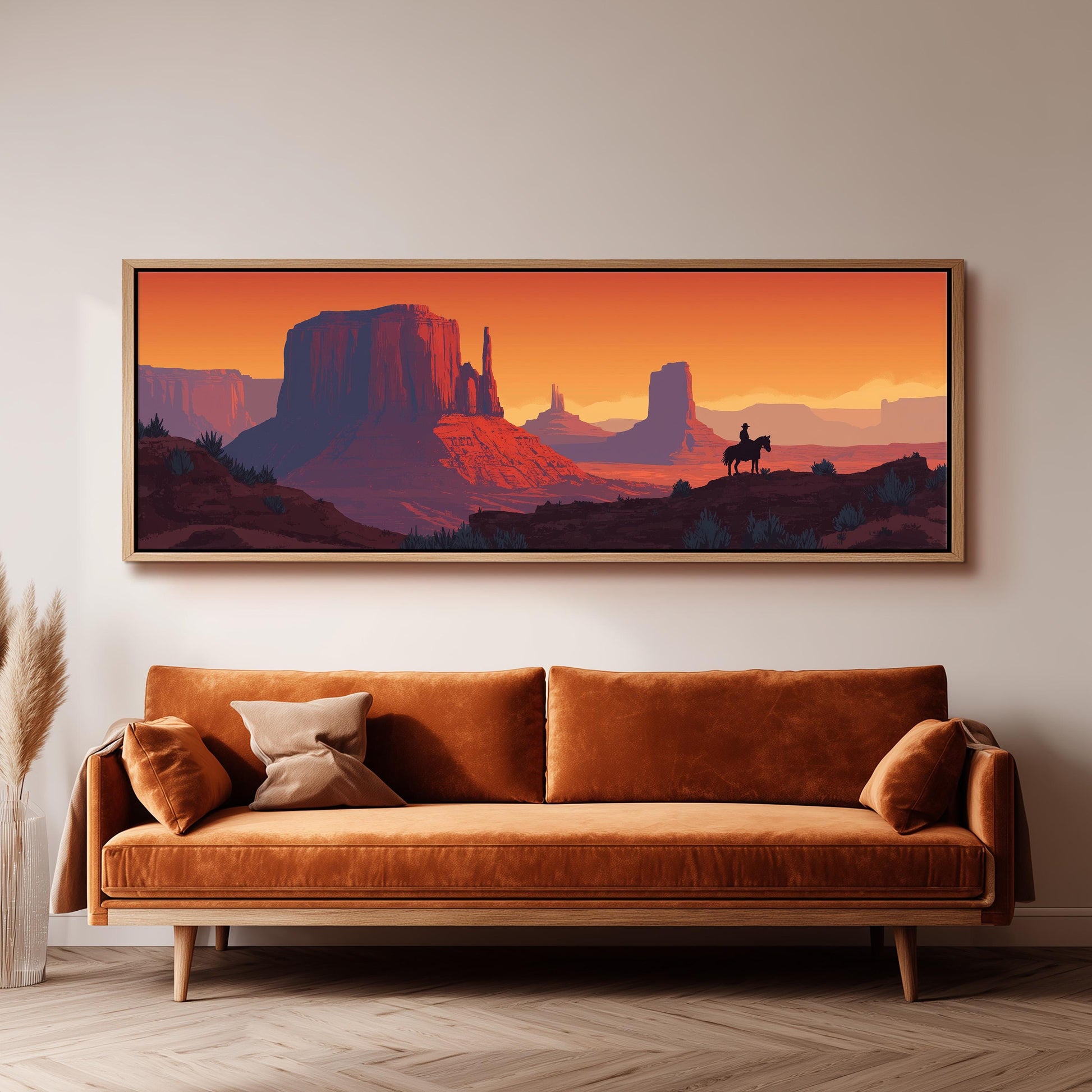 a large, framed painting of a desert landscape with mountains and a cowboy on horseback.