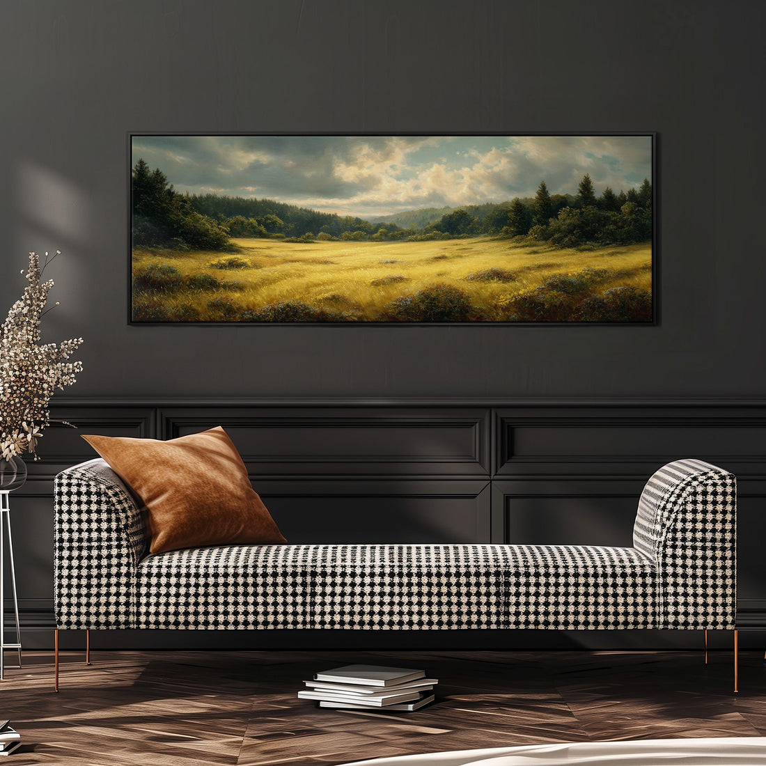 a large landscape painting hanging on a wall above a brown sofa with orange cushions.