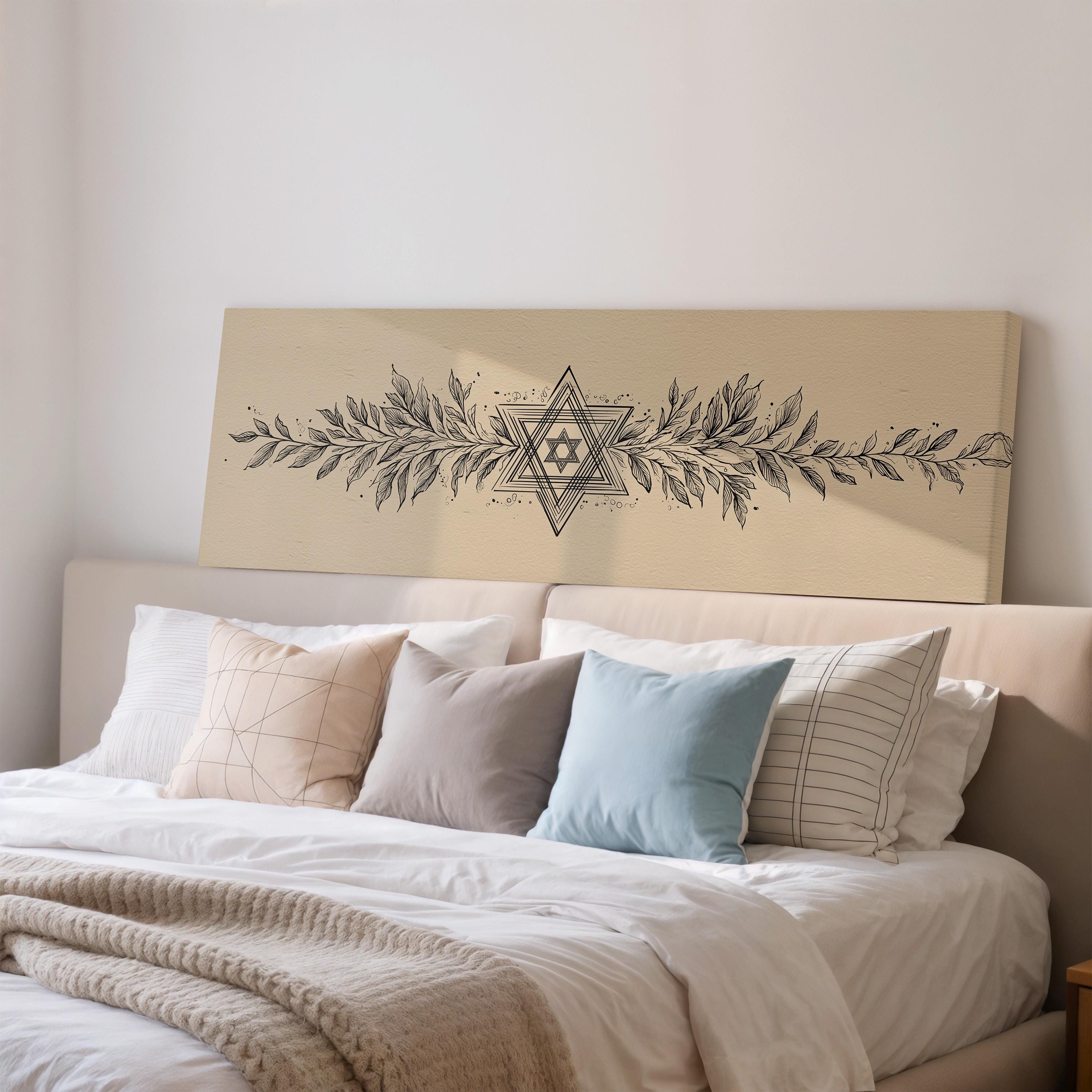 a well-made bed with a variety of pillows and a decorative headboard featuring a geometric design.