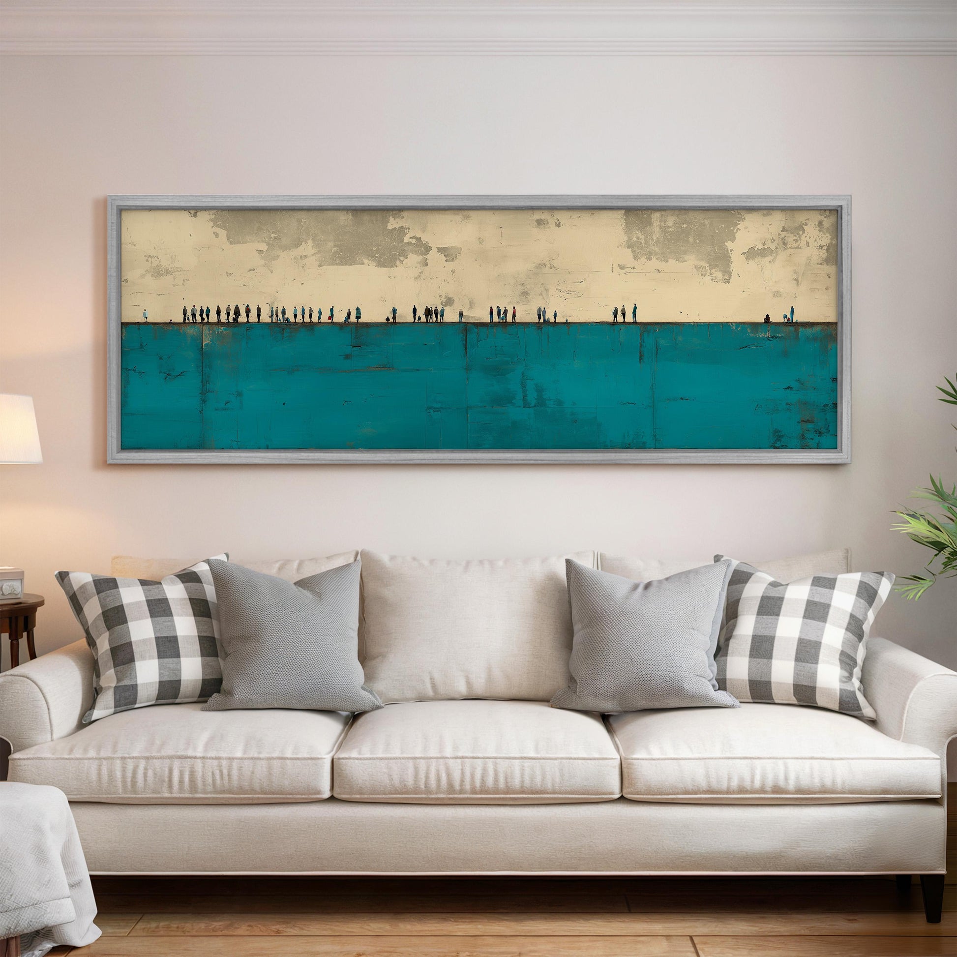 a large, framed painting hanging on a wall above a white couch with gray and white plaid throw pillows.