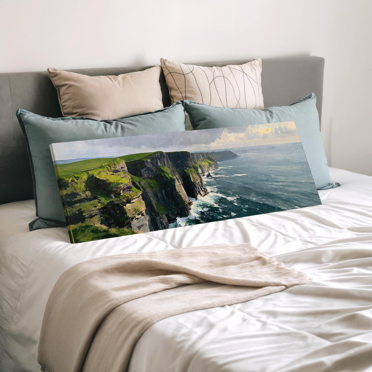 Emerald sea cliffs wide panoramic canvas print laid on a bed to show its size