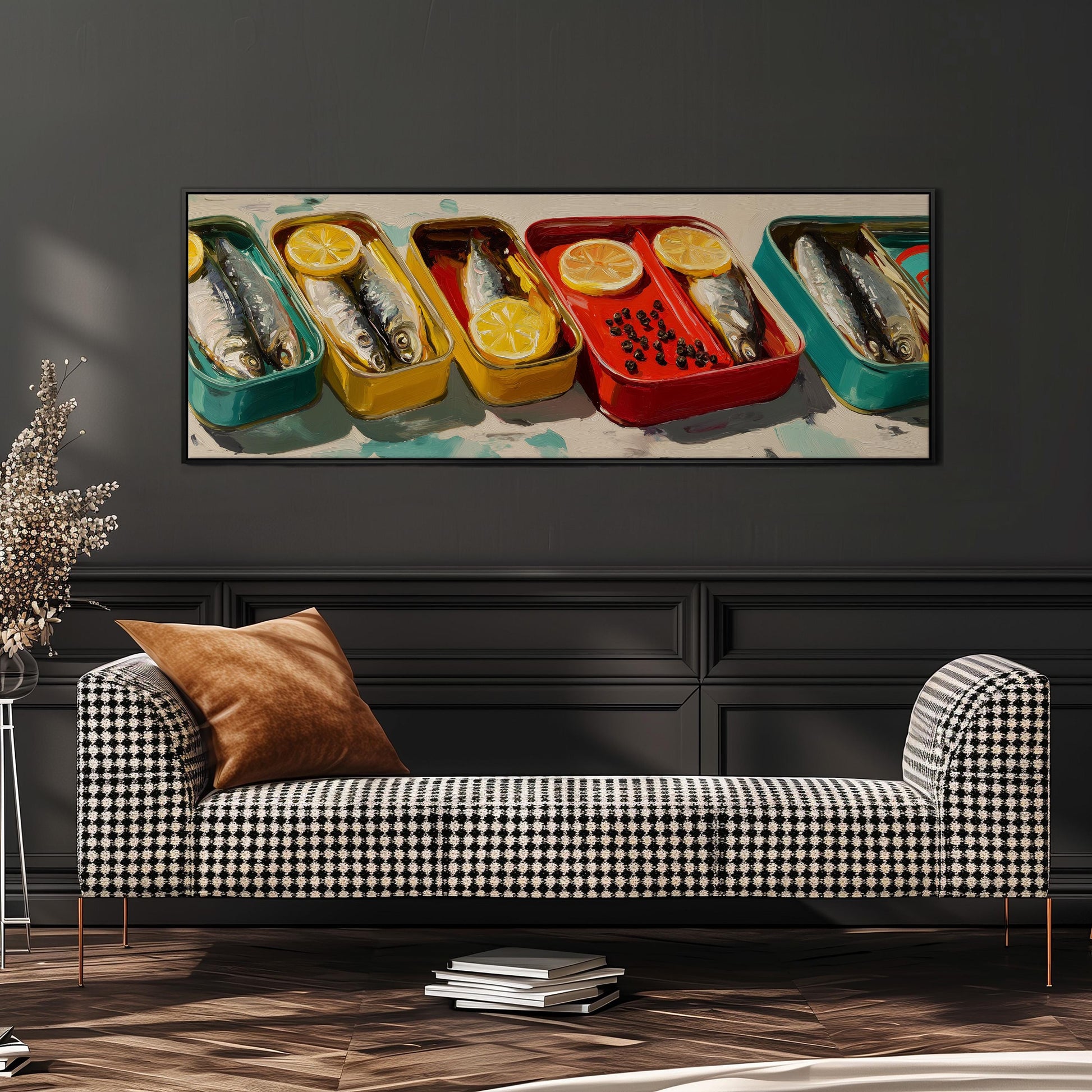 a checkered sofa with a stack of books on the floor in front of it, and a large framed painting of fish in various colored containers hanging on the wall above the sofa.