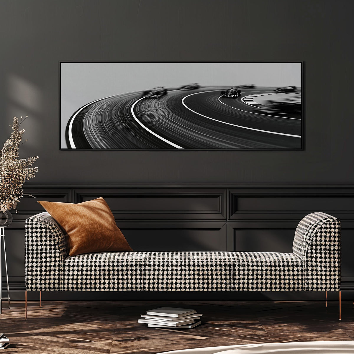 Race cars sweeping around a curve in black and white long horizontal canvas print above a sofa in a living room