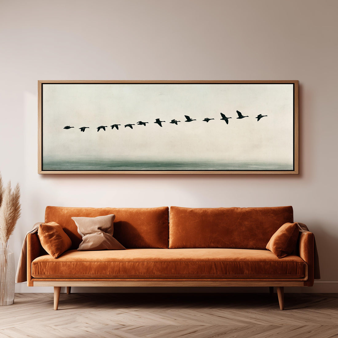 Geese flying over still water long horizontal canvas print above a sofa in a living room