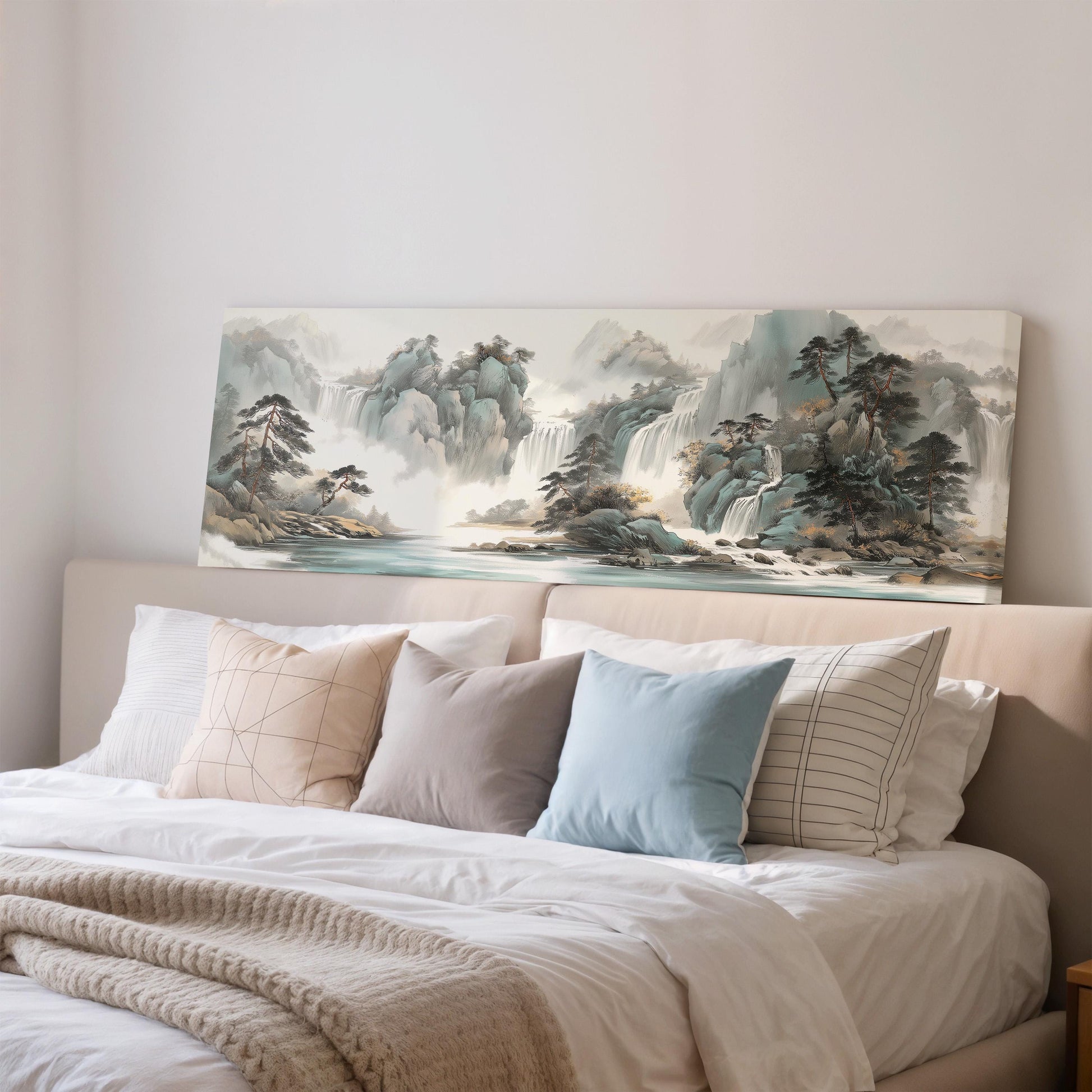 a large landscape painting hanging on a wall above a bed with white bedding and pillows.