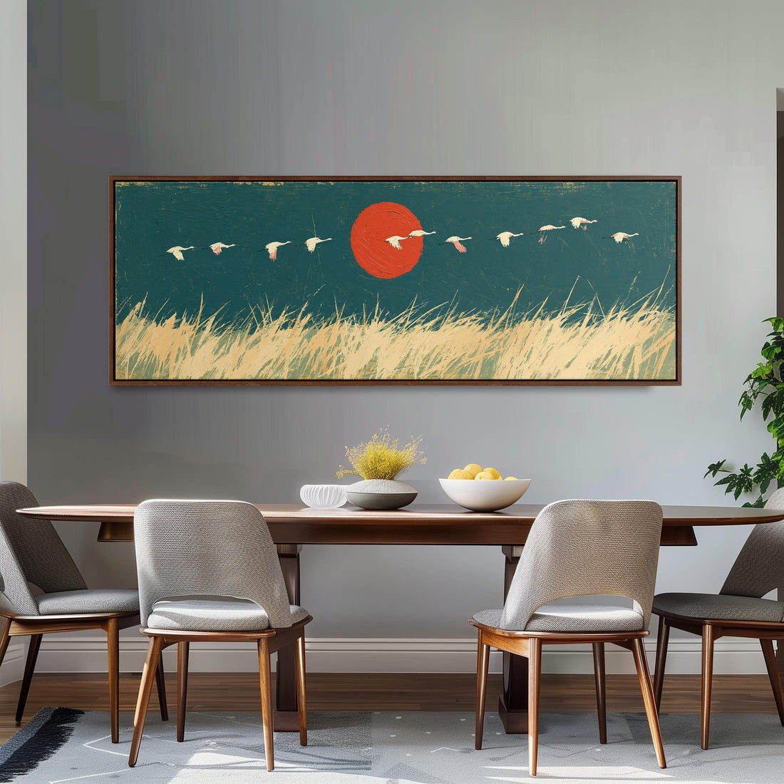 Bird flock over a prairie under a red sun long horizontal canvas print above a sofa in a living room