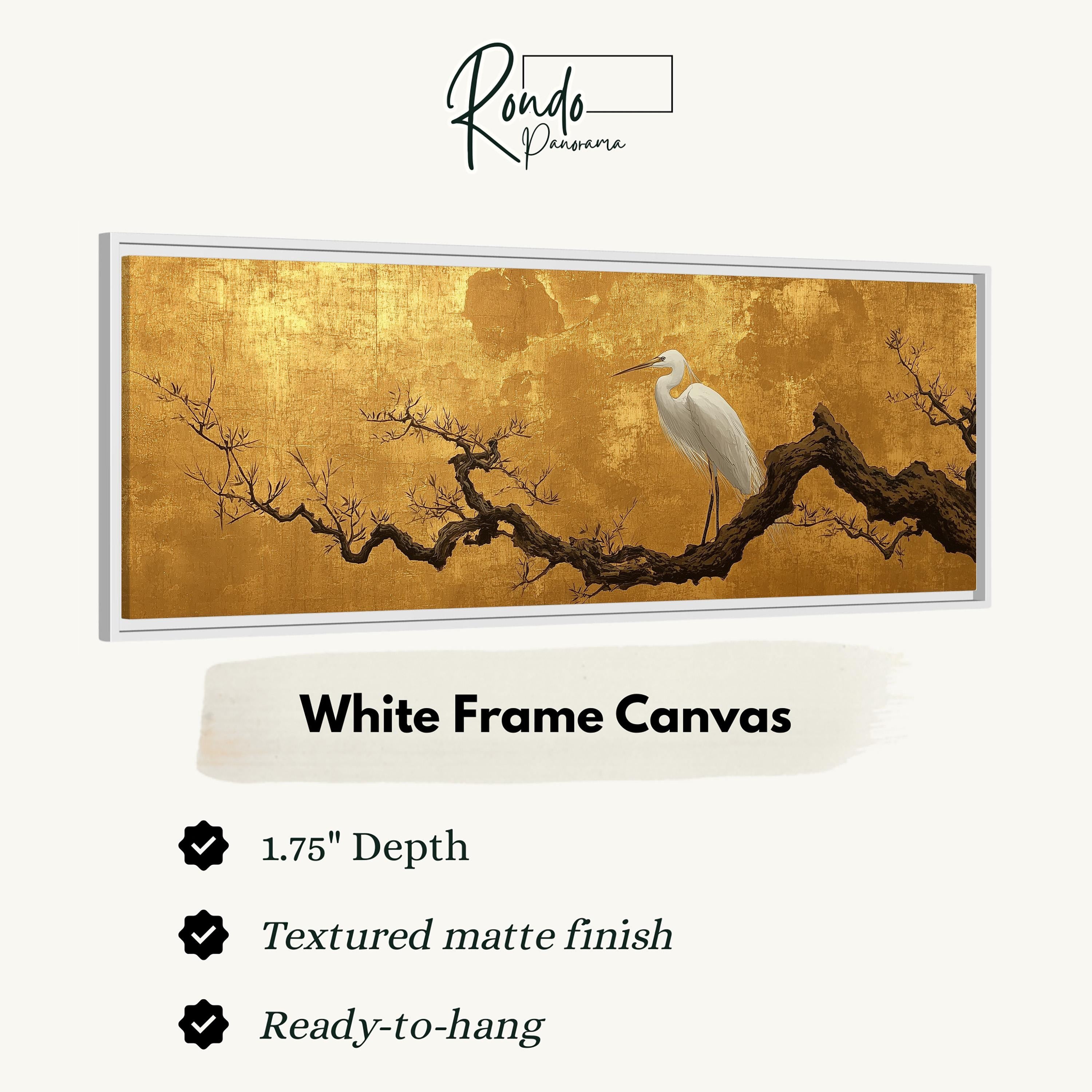 a white frame canvas with a painting of a white egret perched on a branch.