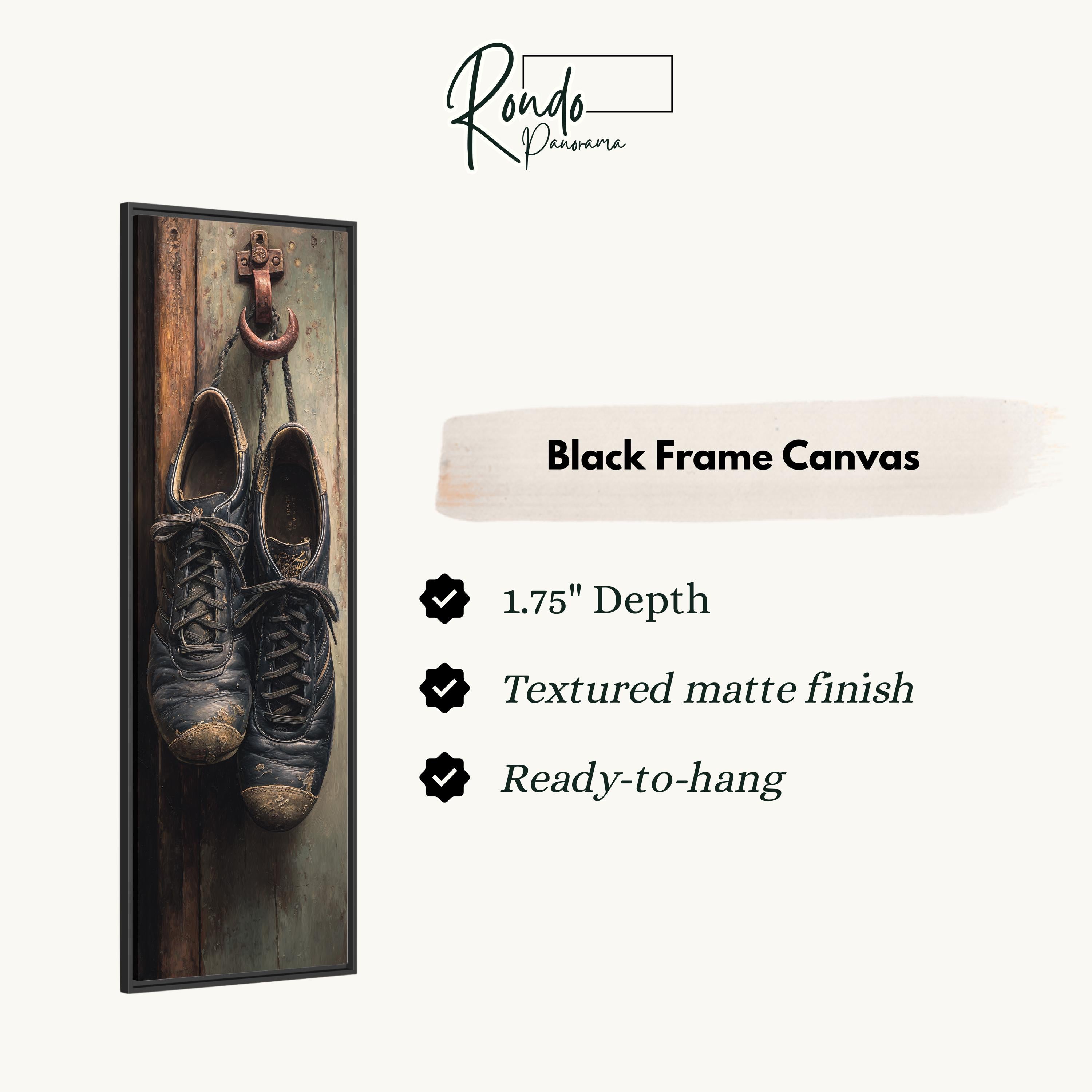 a pair of black shoes hanging on a wooden wall, with a black frame canvas hanging next to them.