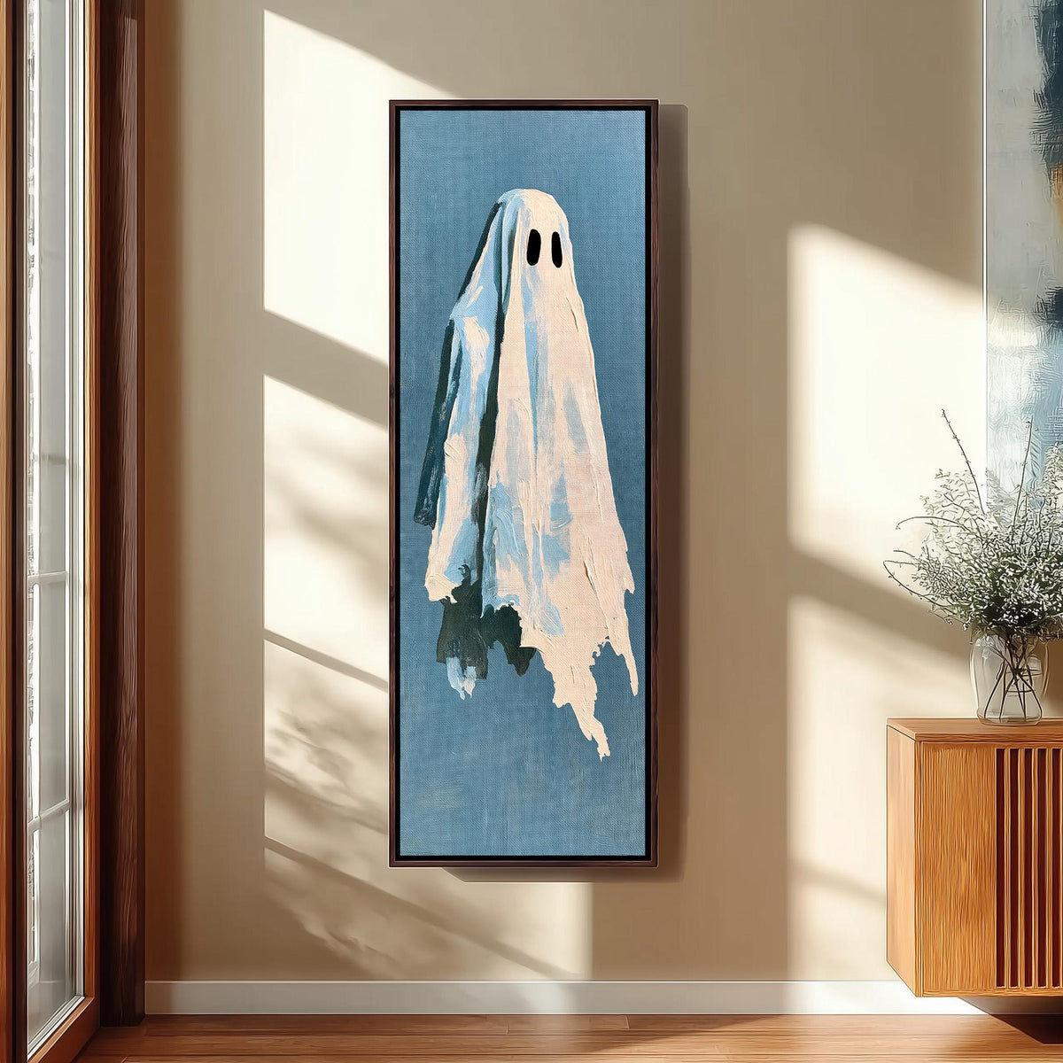 Folk art ghost on blue long vertical canvas print in a sunlit living space