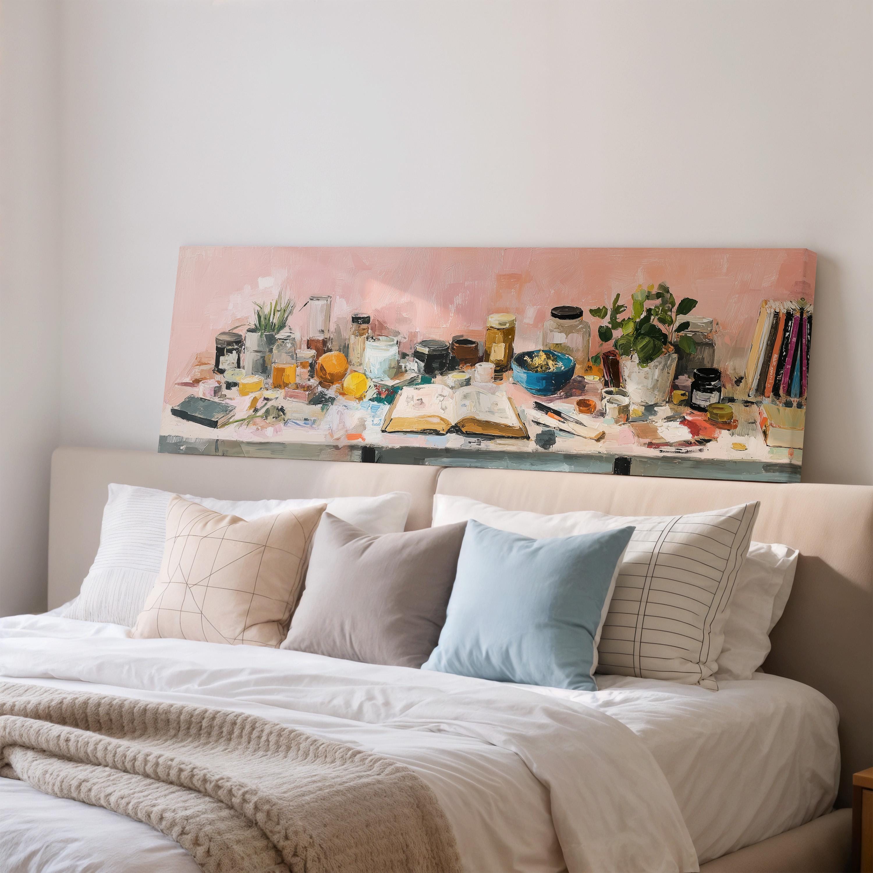 a bedroom with a bed, a large painting of various objects on the wall above it, and a bookshelf filled with books and other items.