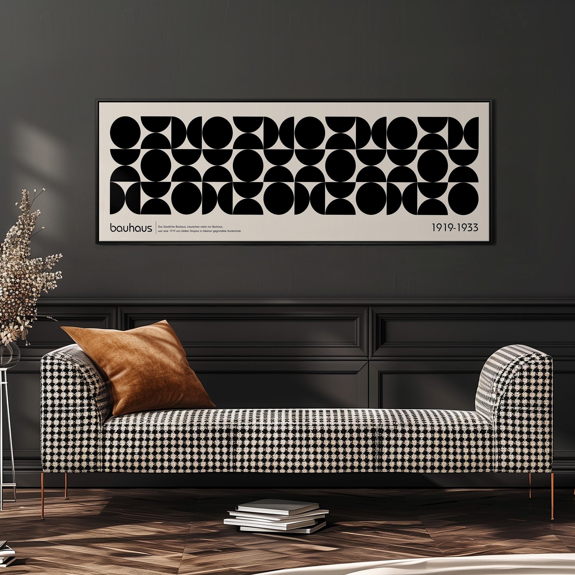 a modern black and white checkered sofa with a brown throw pillow, set against a dark wall with a framed abstract art piece above it.