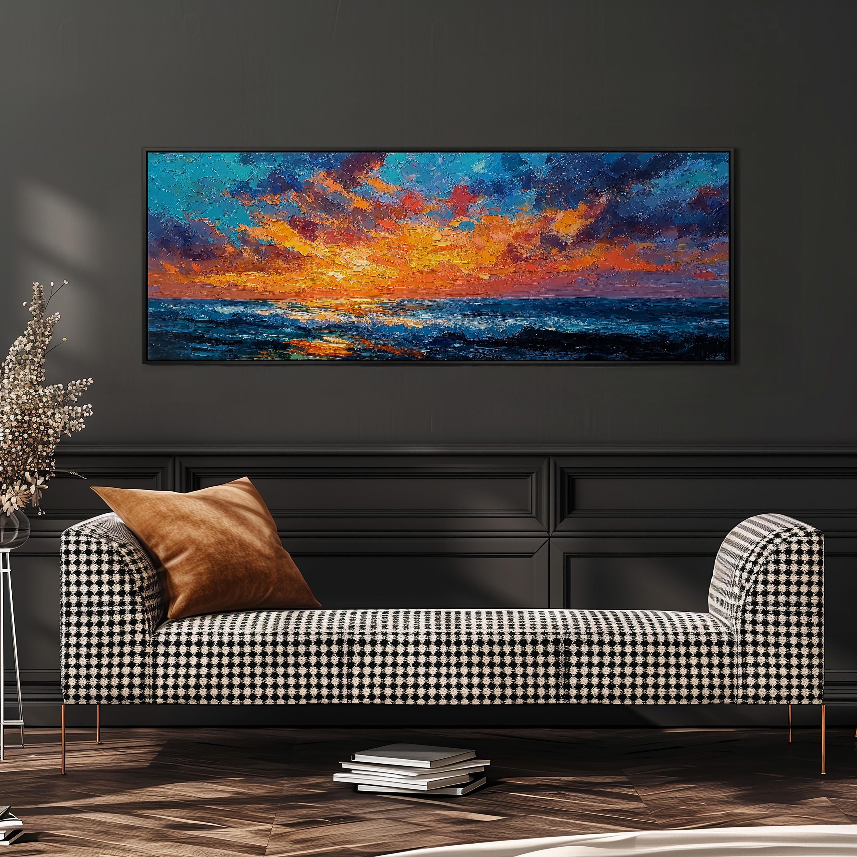 a large, colorful painting of a sunset over the ocean, hanging on a wall above a black and white checkered sofa.