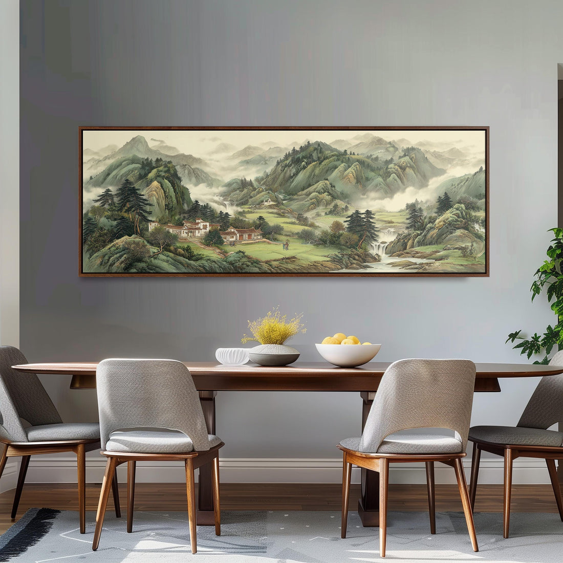 a large landscape painting hanging on a wall above a brown sofa with orange cushions.