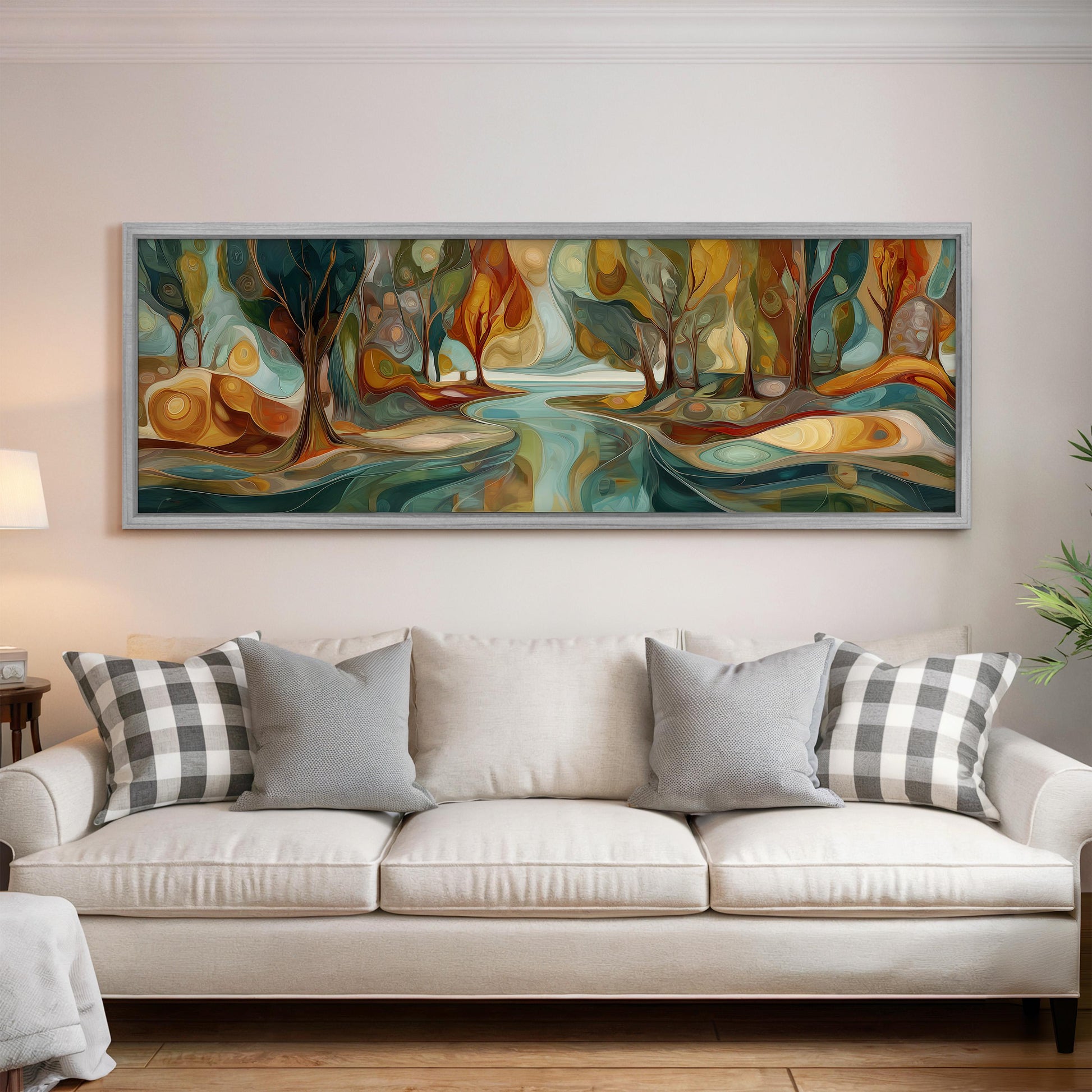 a large, colorful painting of a forest scene hanging on a wall above a white couch with gray and white plaid throw pillows.