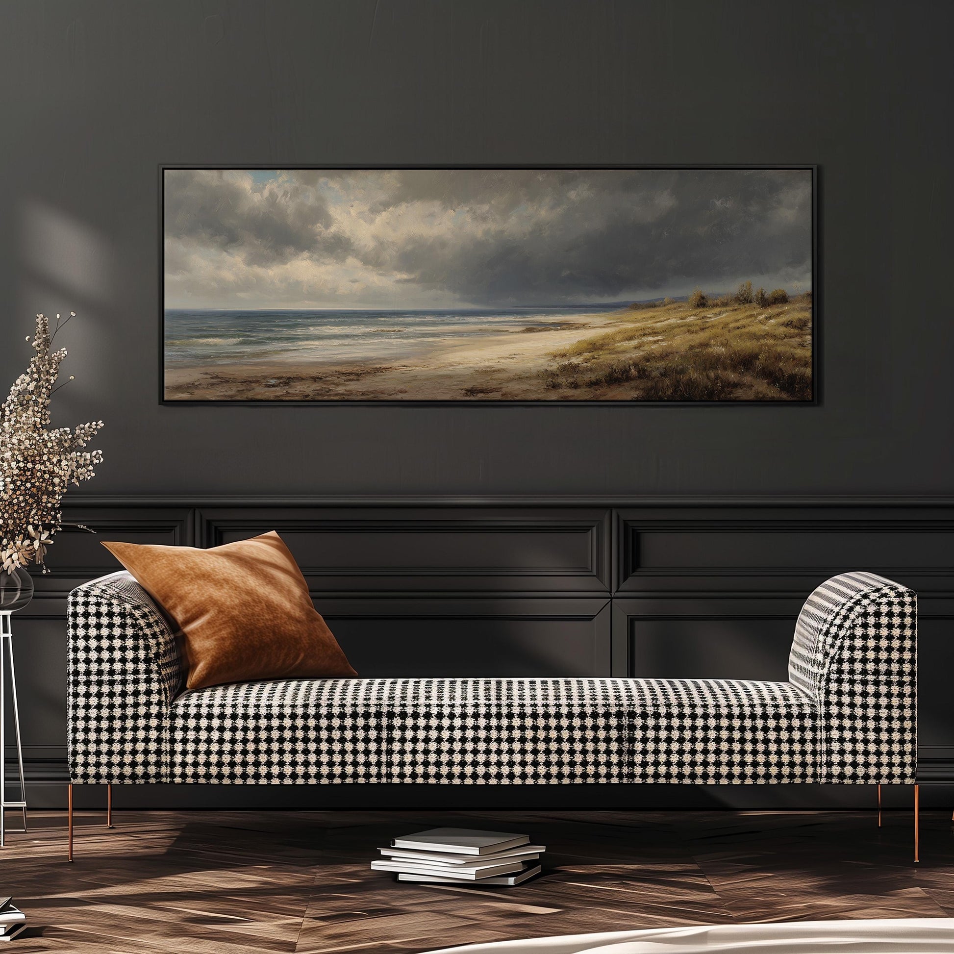 a large painting of a beach scene hanging on a wall above a black and white checkered sofa with a brown throw pillow.
