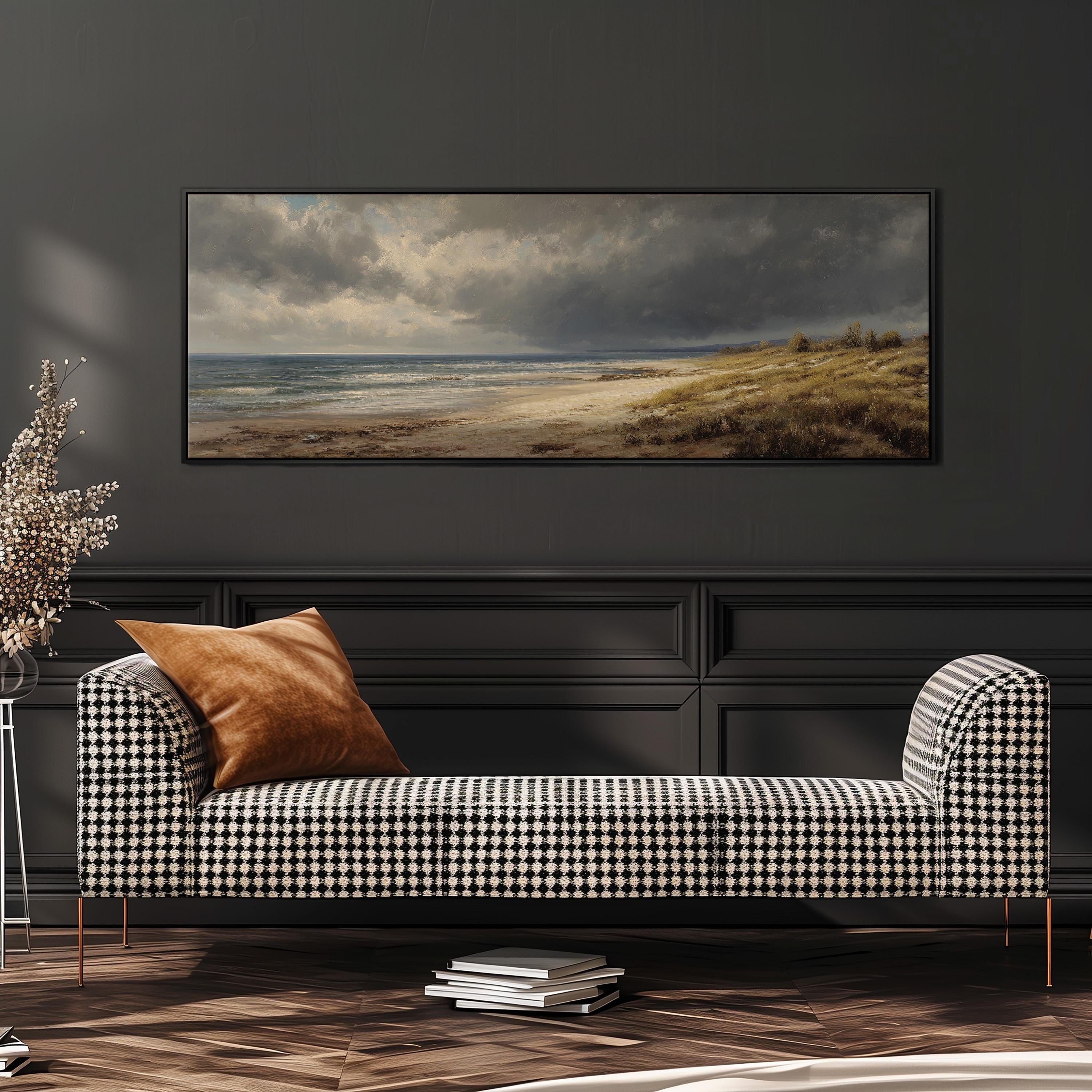 a large painting of a beach scene hanging on a wall above a black and white checkered sofa with a brown throw pillow.