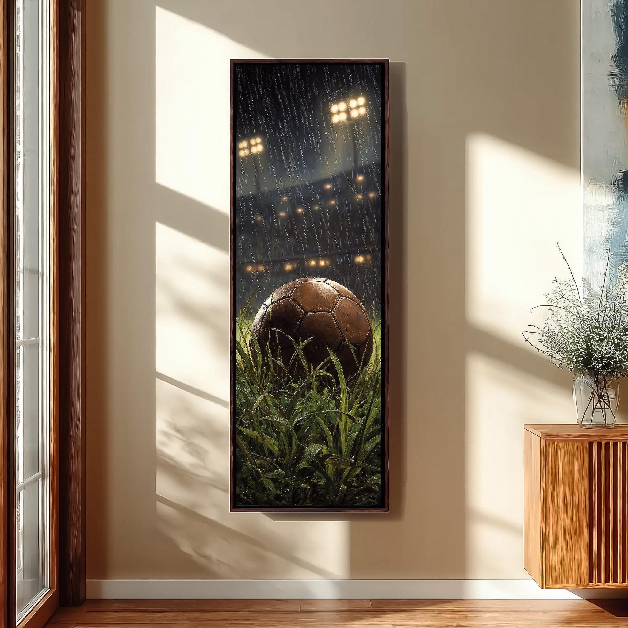 a framed painting of a soccer ball in a grassy field, with a rainy night scene in the background.
