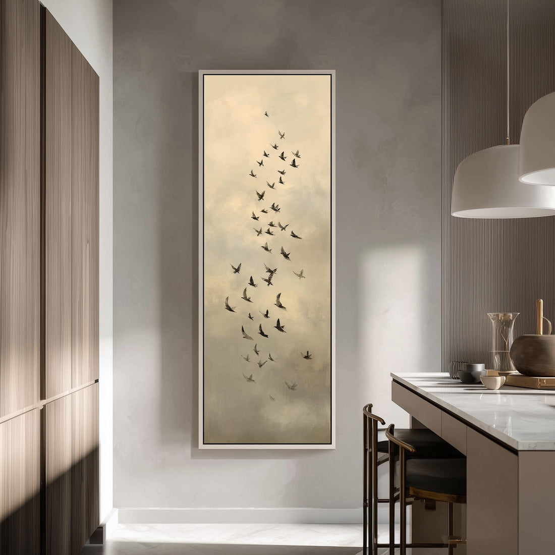a large framed artwork depicting a flock of birds in flight, hanging on a wall in a modern kitchen setting.