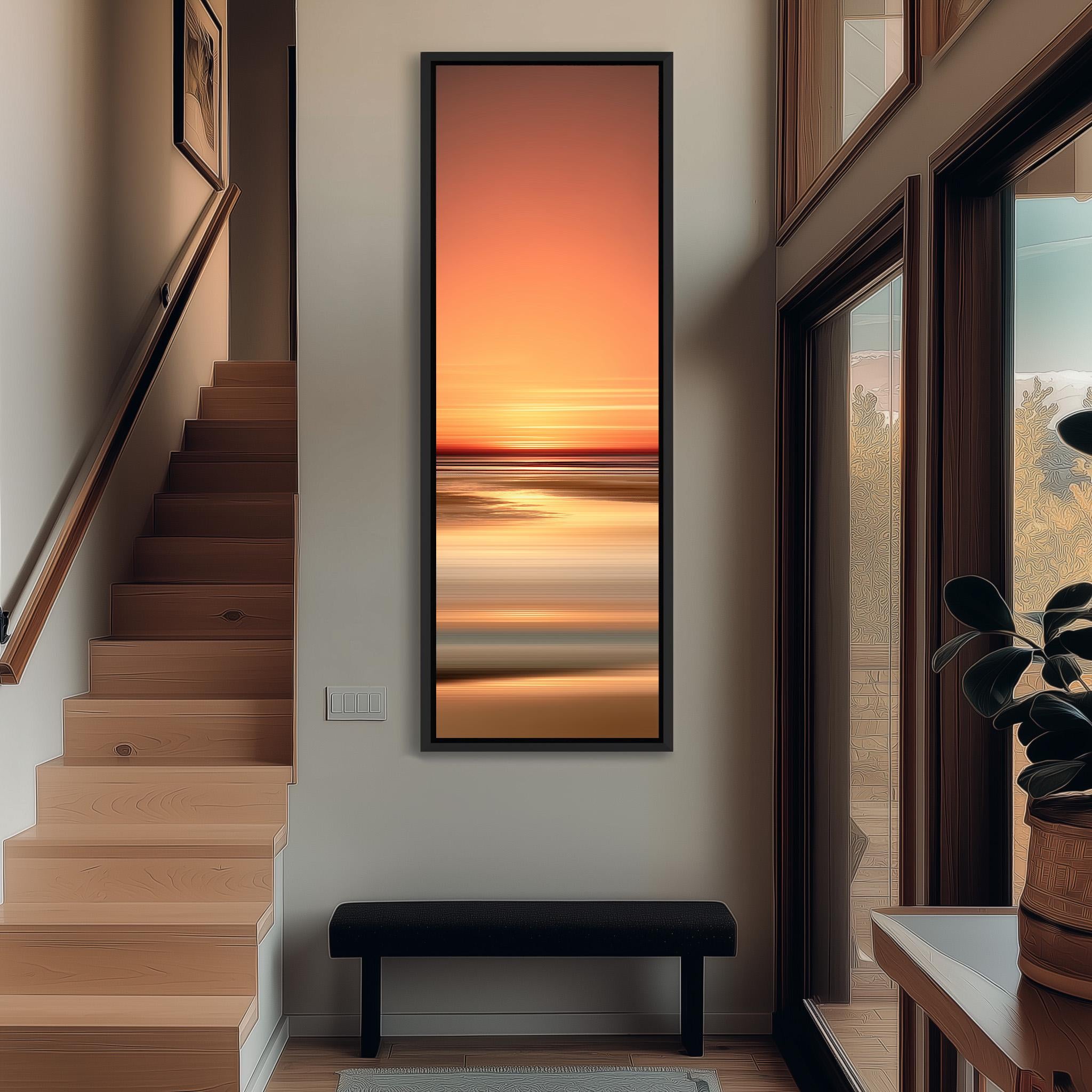 a modern interior design with a large, vibrant painting of a sunset hanging on the wall. The painting is framed in black and is positioned above a black bench, which is situated in front of a window. The staircase leading to the second floor is also visible in the image.