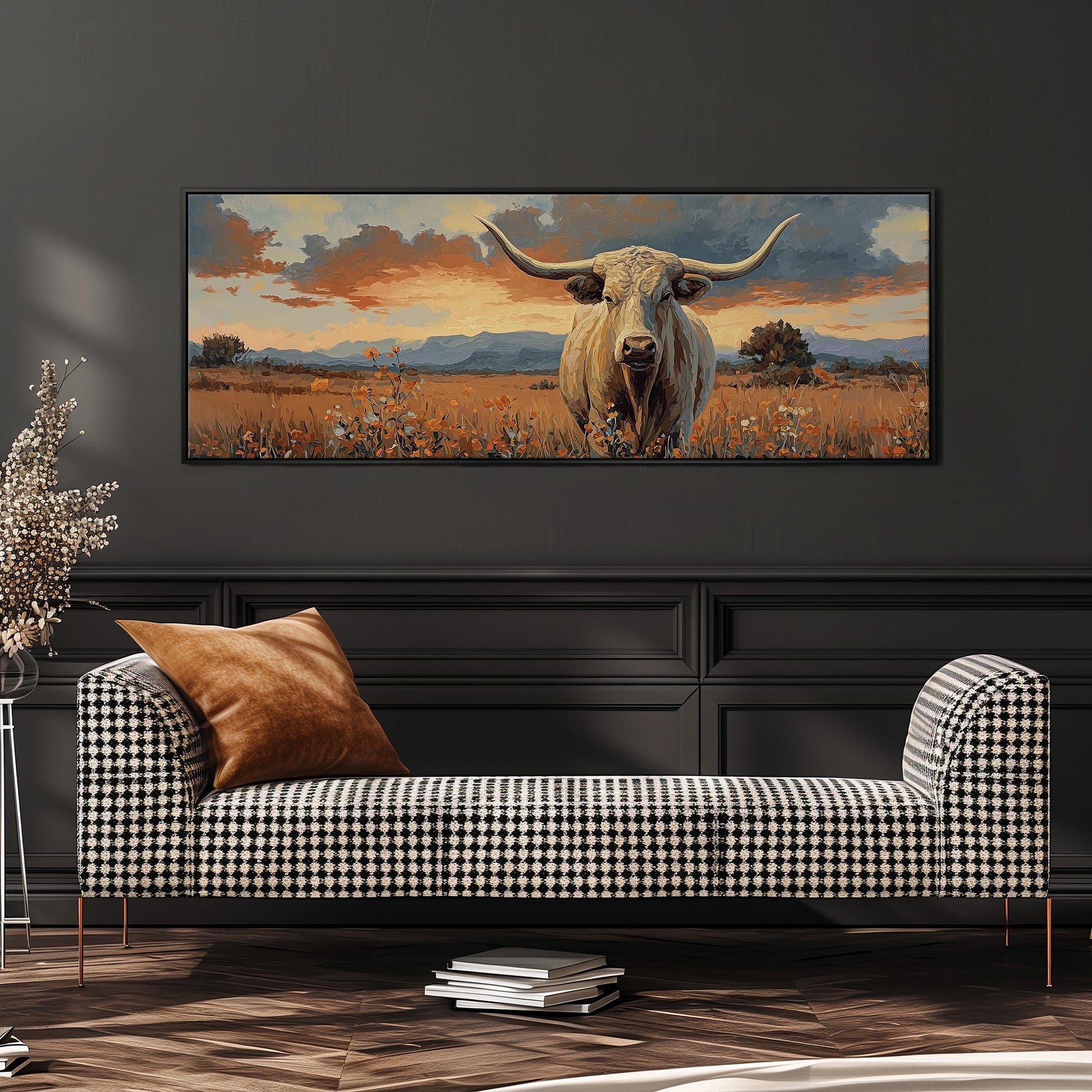 a large painting of a bull with horns, displayed on a wall above a black and white checkered sofa.