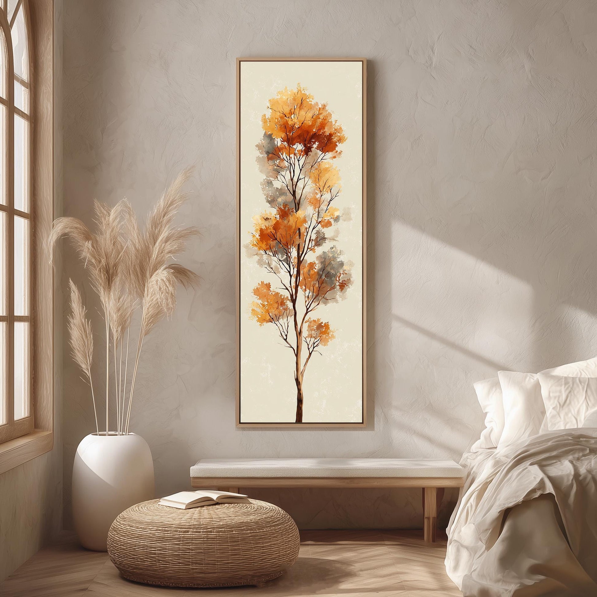 a serene and cozy bedroom scene, featuring a large painting of a tree with vibrant orange leaves hanging on the wall, a white bed with a white pillow and blanket, a white vase with tall potted plants, and a woven ottoman in front of the bed.