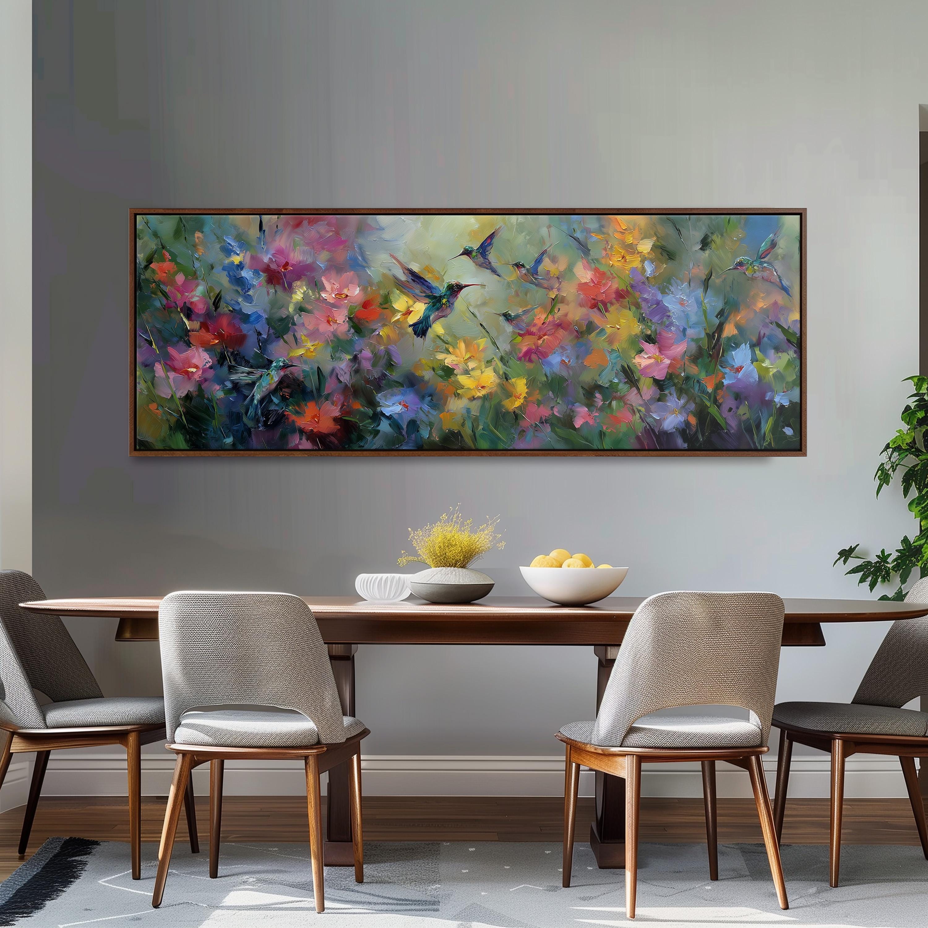 a dining room with a large painting of colorful flowers hanging on the wall above a wooden table with four chairs. The table is set with a bowl of fruit and a vase of flowers, creating a welcoming and vibrant atmosphere.